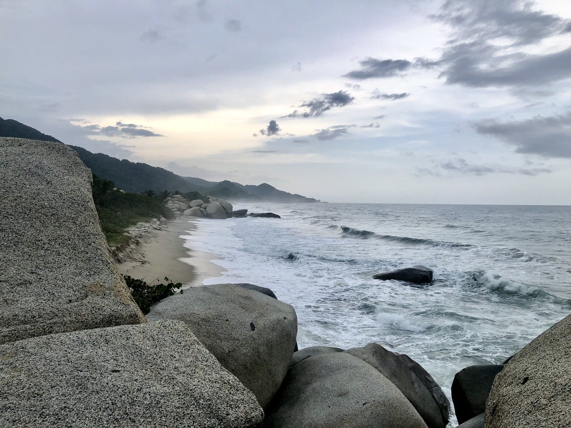 Tayrona National Park, Colombia The rugged coastline of Tayrona National Park at dusk, where mountains meet the Caribbean Sea.