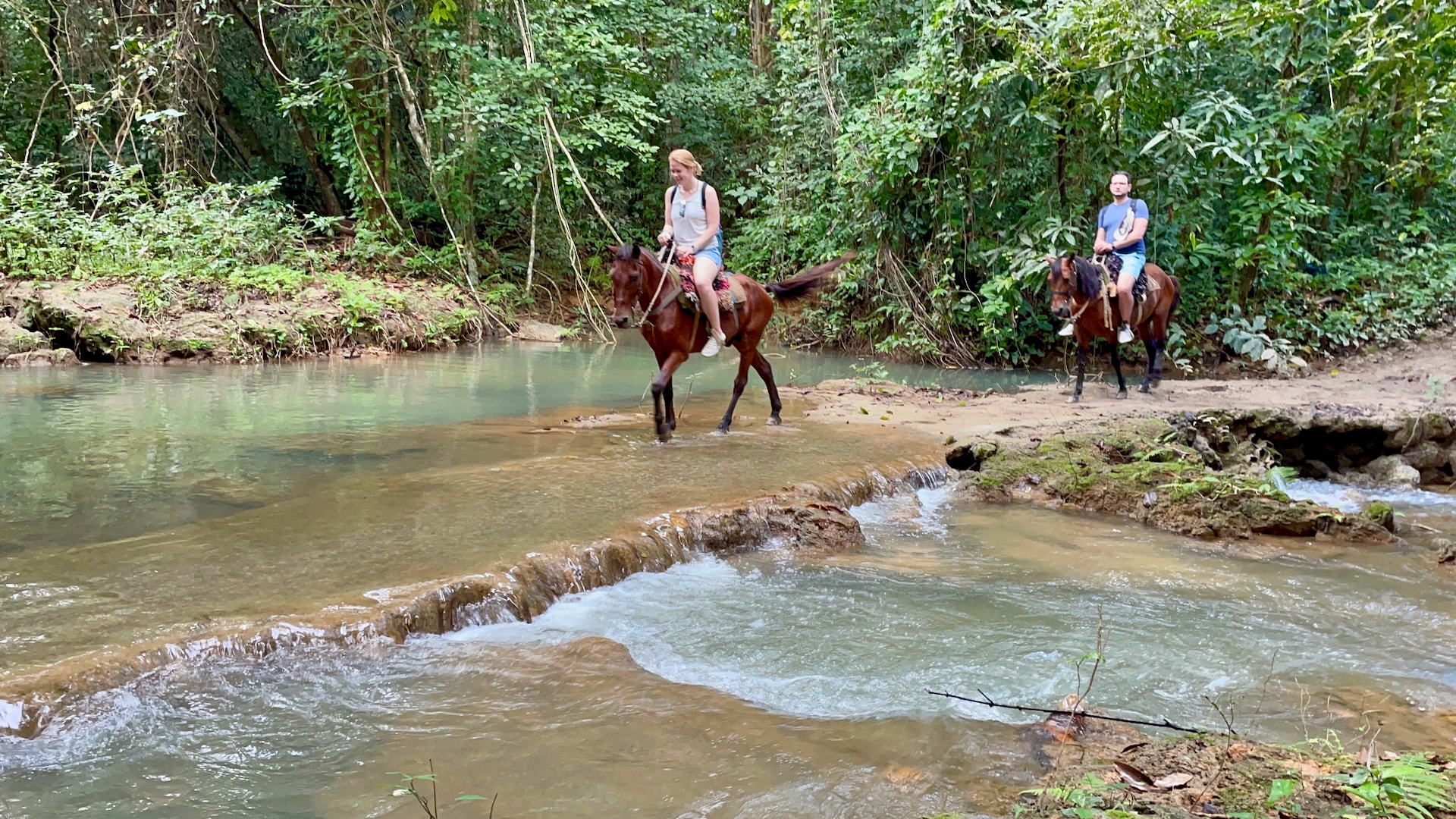 El Limón waterfall, Dominican Republic Crossing a small stream with the horses.