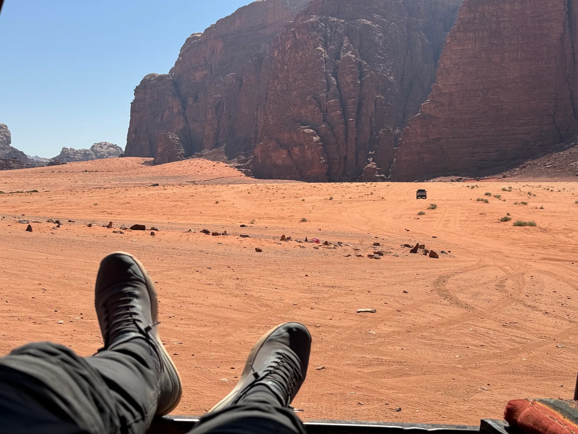 Chilling on a pickup truck bed in Wadi Rum, Jordan, wearing my Tropicfeel Canyon shoes.