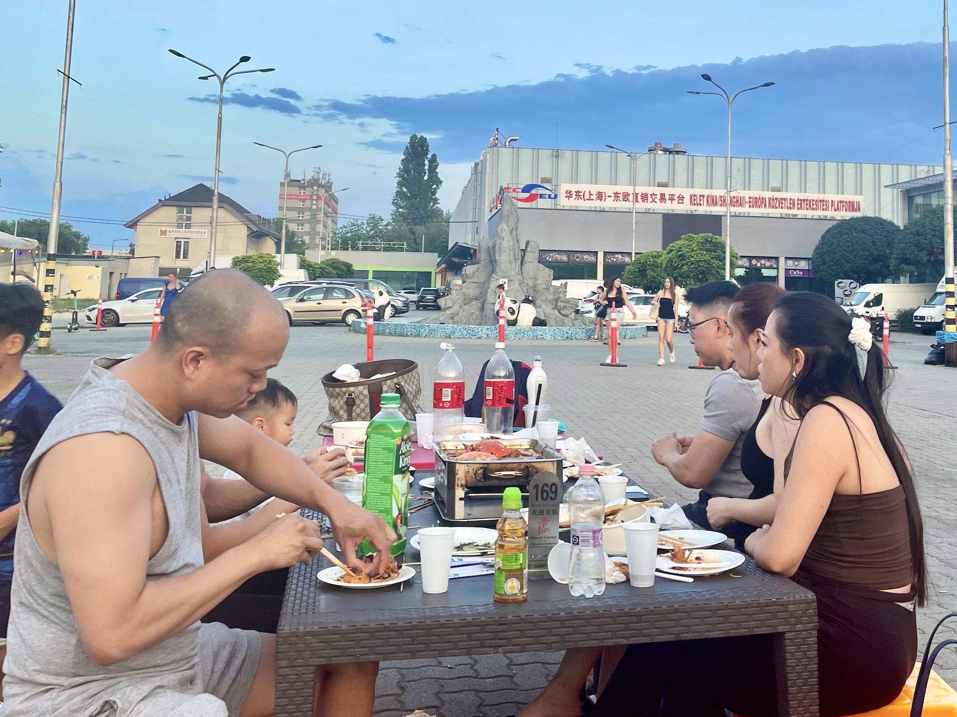 Budapest Chinatown Night Market Hotpot dining with the distinctive panda fountain visible in the background.
