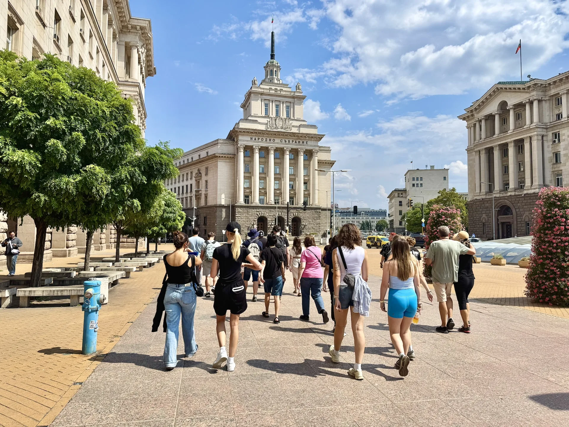 The old party building, now the parliament building, in front of it is our group participating in the tour.