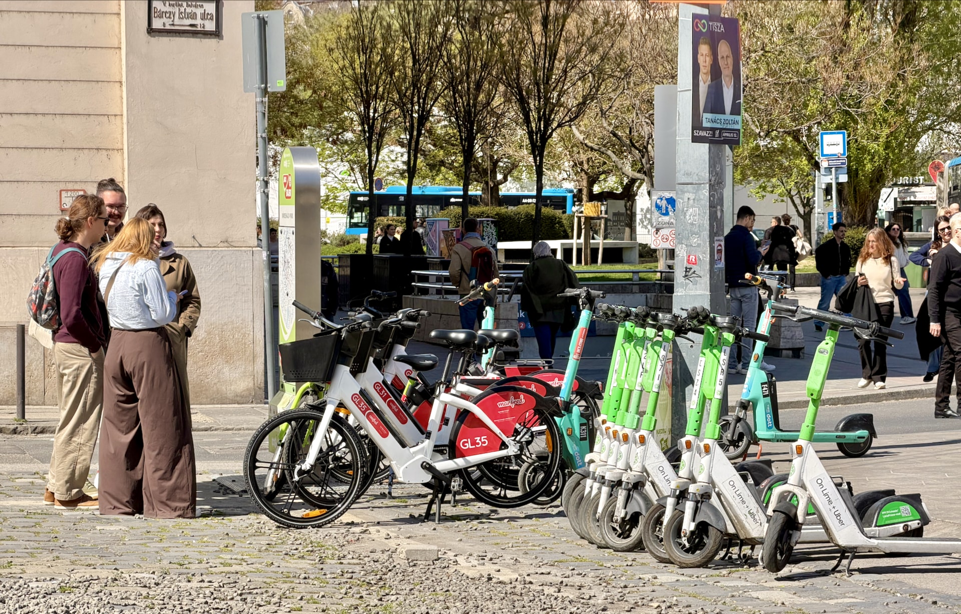 Lime e-scooters and bikes from a smaller local bike rental service. This spot will likely host the new Bubi bikes soon.