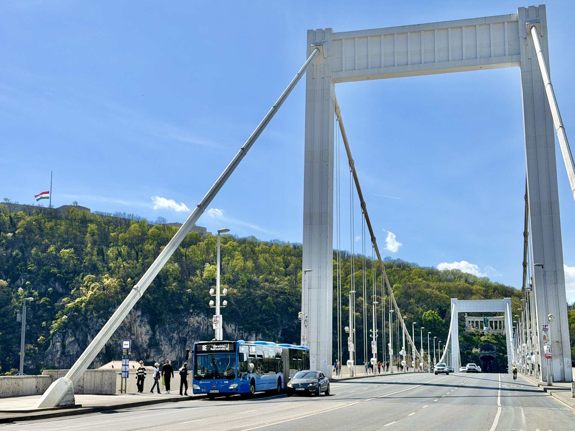 Bus on Elizabeth Bridge, with Gellért Hill and the Citadella in the background.