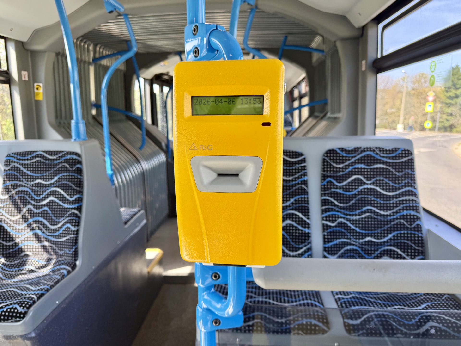 Ticket validator on a bus.