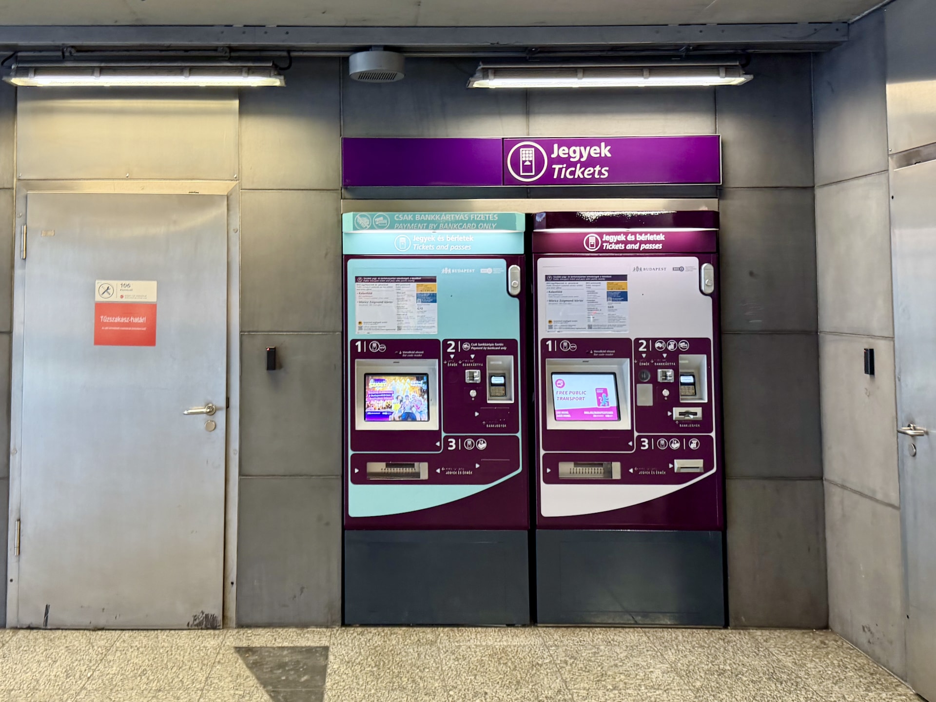Ticket machines at a metro station. The one on the left takes cards only; the one on the right also accepts cash.