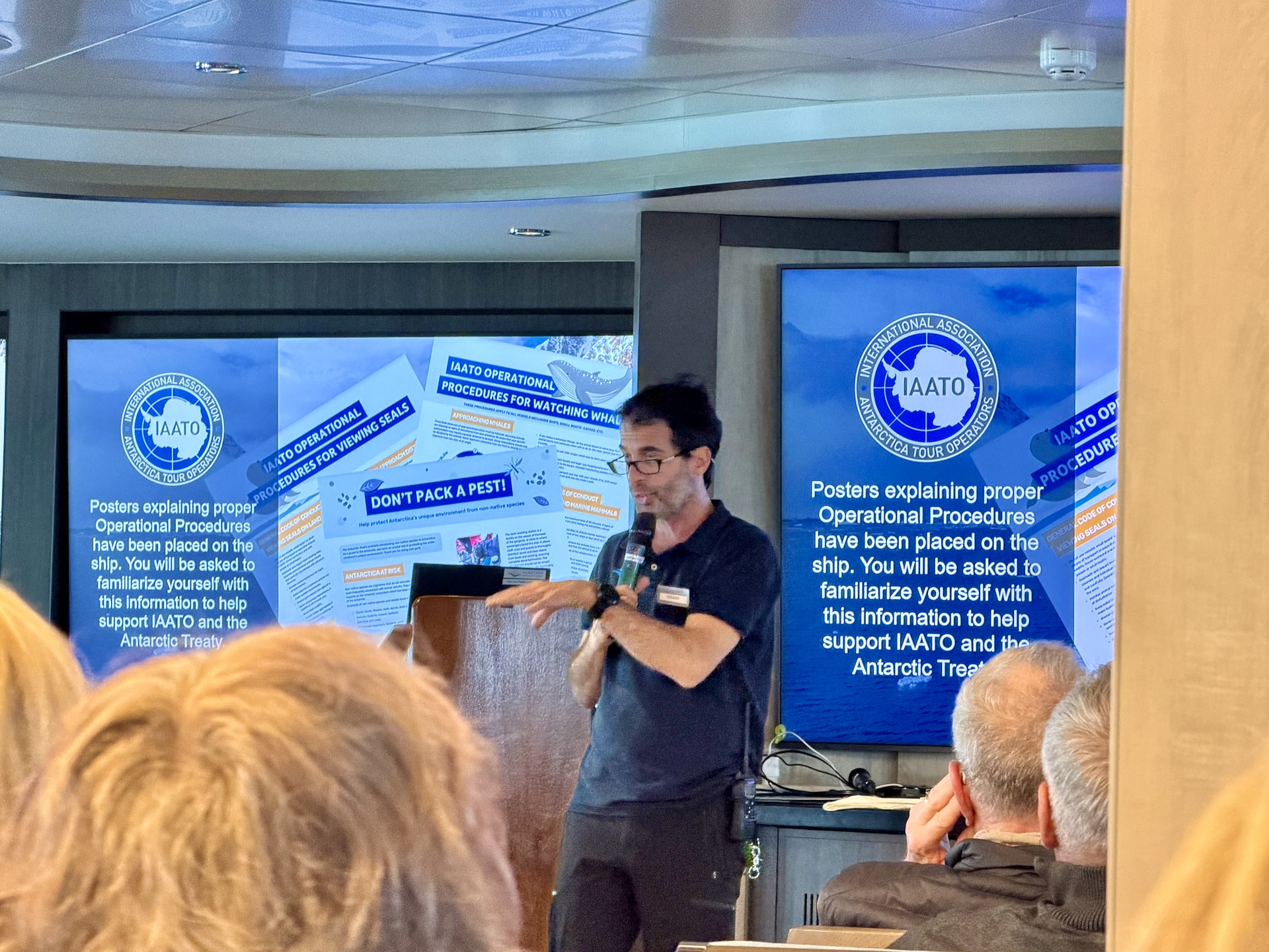 Expedition leader Diego Punta Fernández delivering the mandatory IAATO Operational Procedures briefing during the Drake Passage crossing
