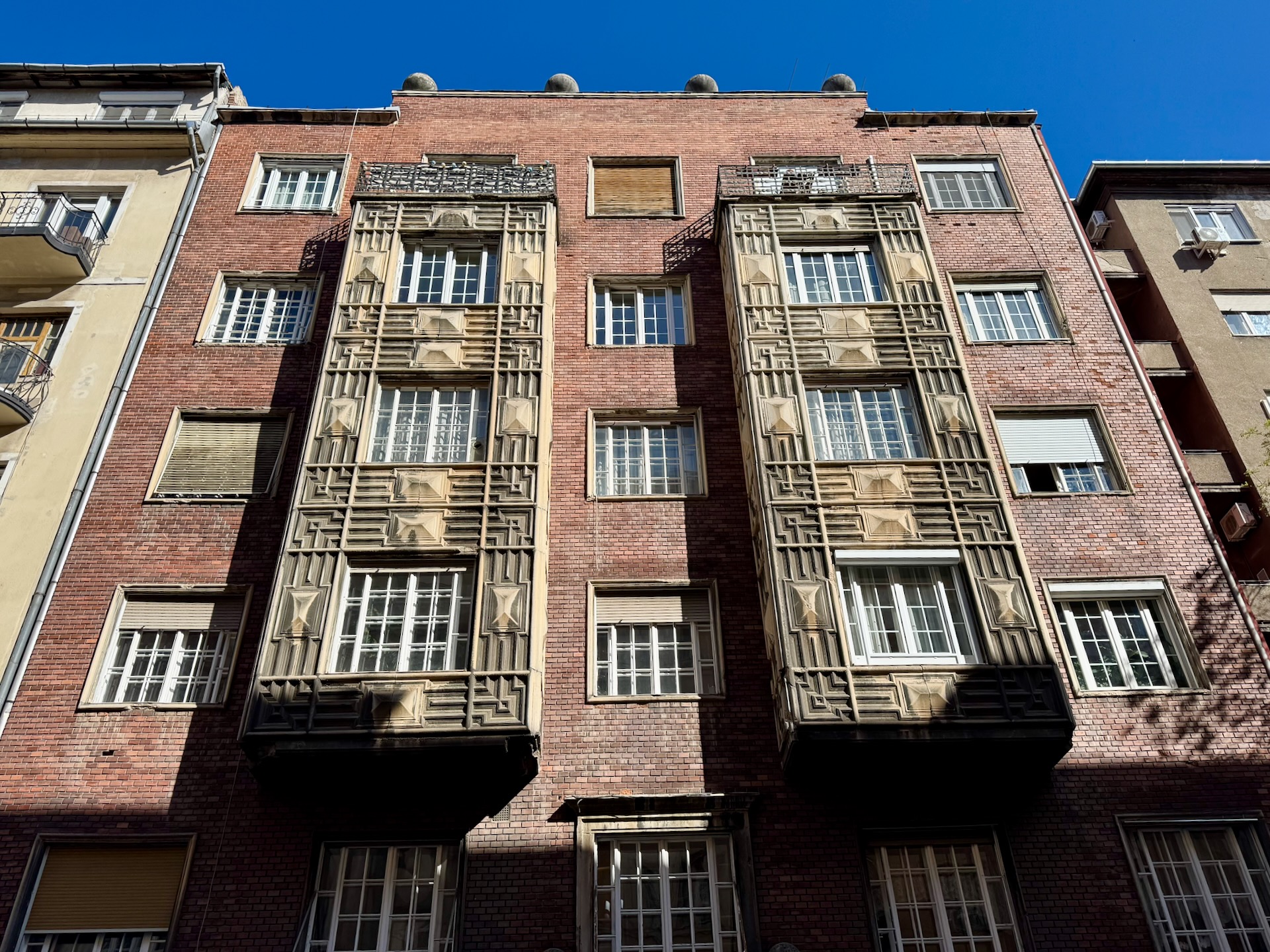 Clinker brick apartment building facade with geometric Art Deco window detailing in Újlipótváros Budapest