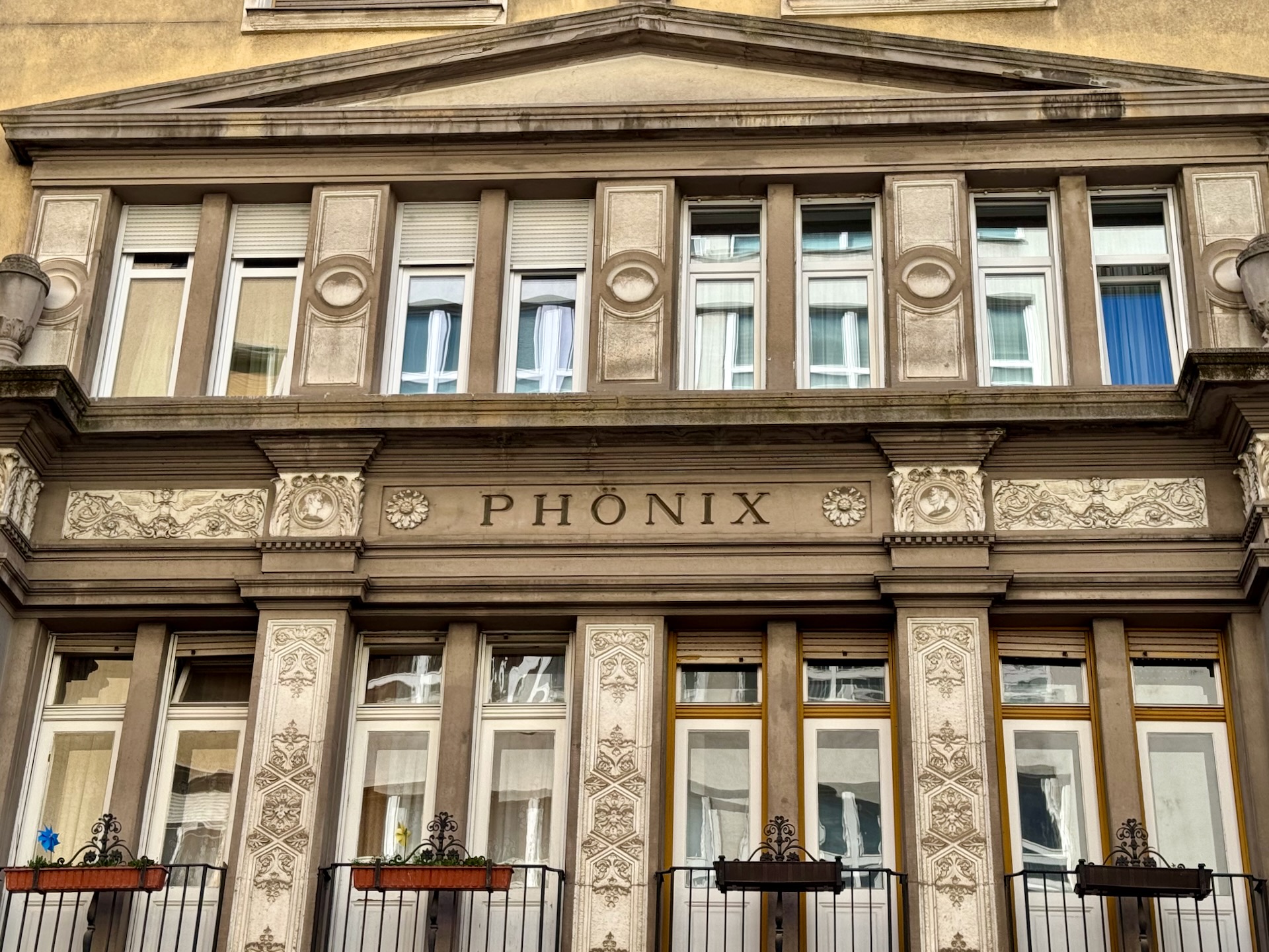 Phönix insurance building facade detail with PHÖNIX lettering in Budapest 13th district
