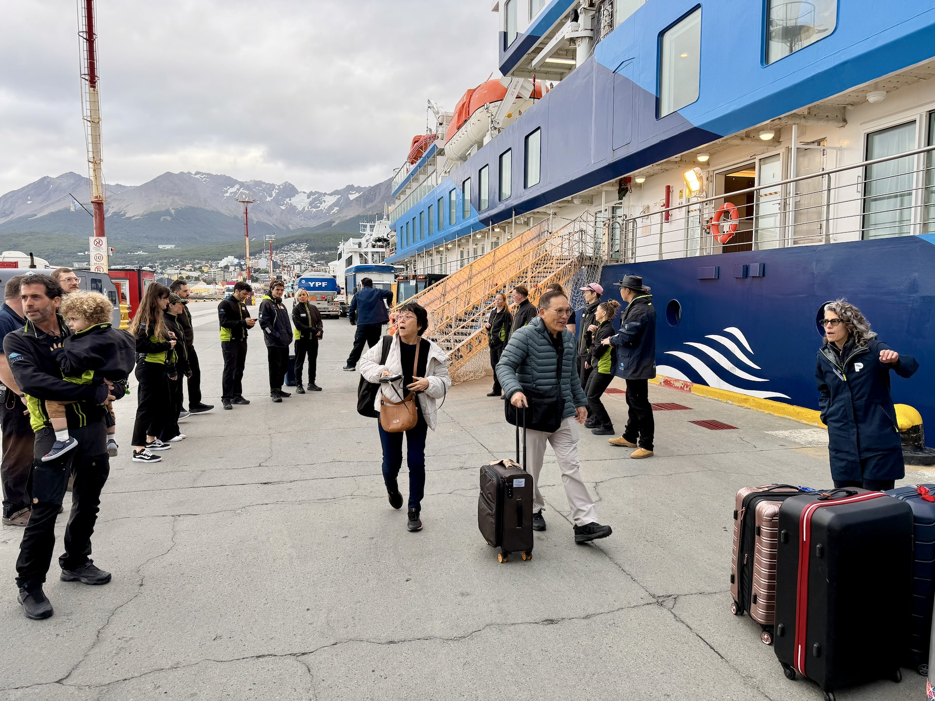 Disembarkation in Ushuaia: expedition leader Diego greets his small child on the dock after returning from an Antarctic voyage