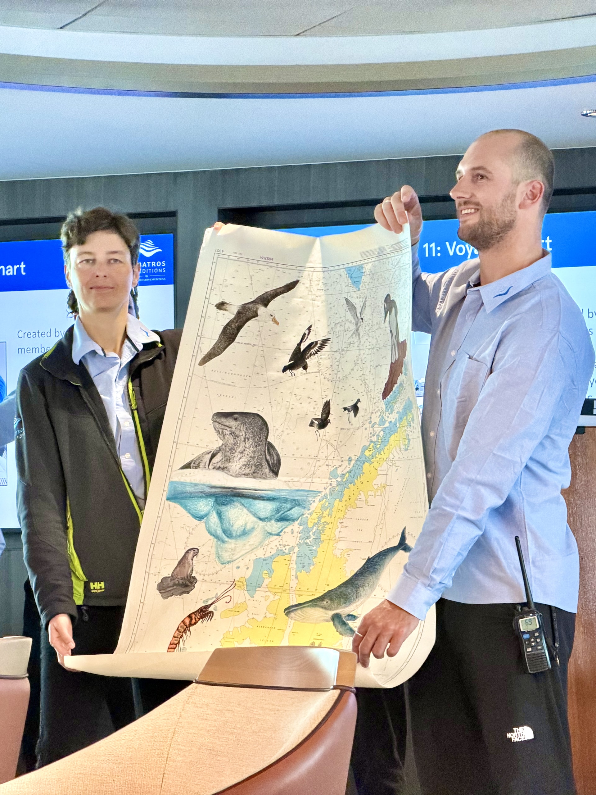 Printed Antarctic Peninsula chart hand-illustrated by expedition guides with sketches of seals, whales, and icebergs, sold at the end-of-voyage charity auction