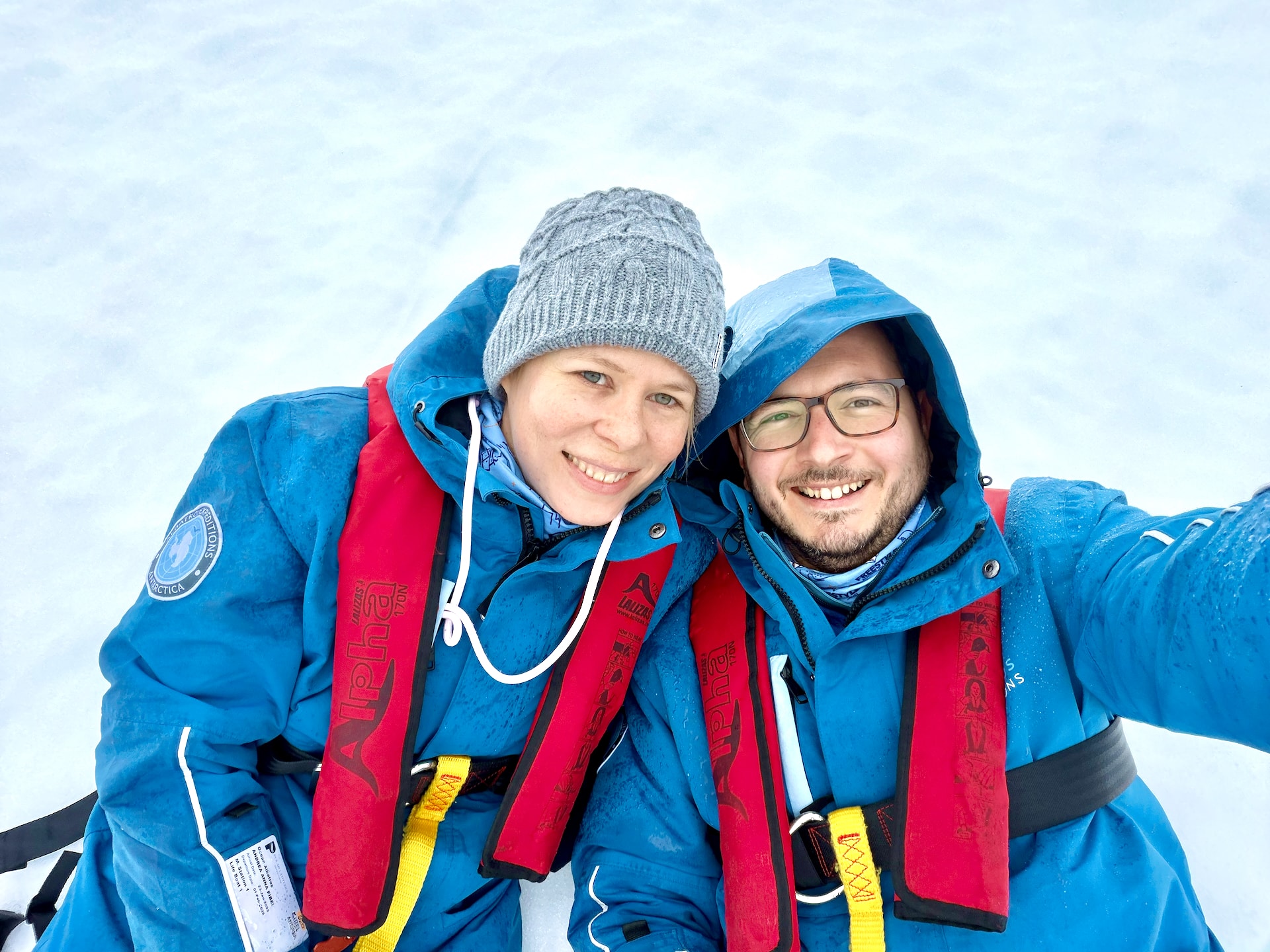 Cruise passengers lying in the snow at Portal Point on the Antarctic Peninsula