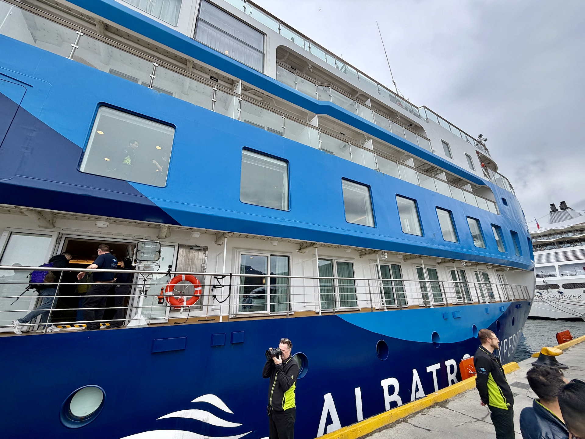 Ocean Albatros expedition cruise ship docked at Ushuaia port, photographed from the pier just before embarkation