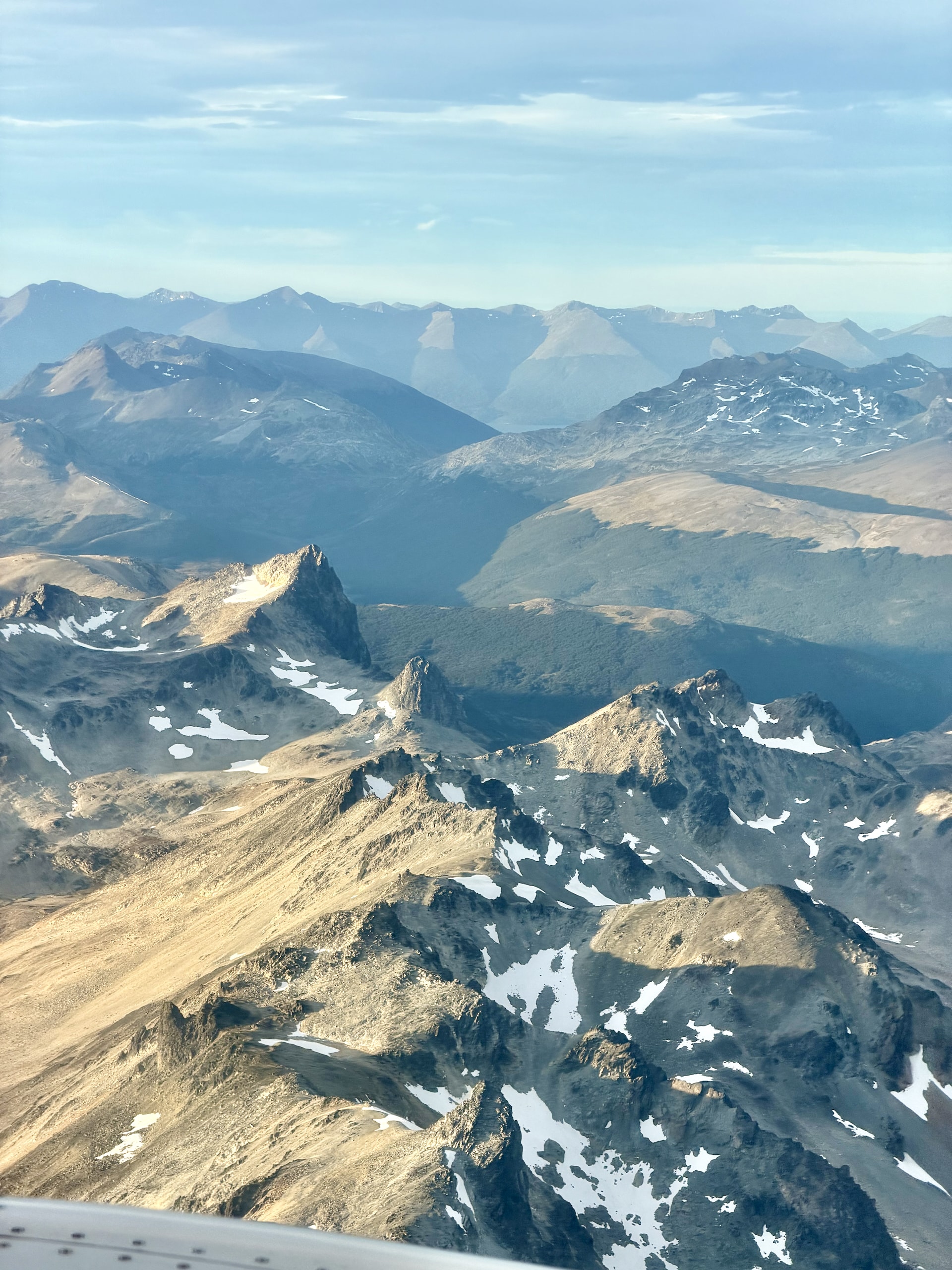Aerial view Patagonian Andes mountains approaching Ushuaia Aerial view of snow-capped Patagonian Andes mountains with glacial lakes and valleys on the approach into Ushuaia