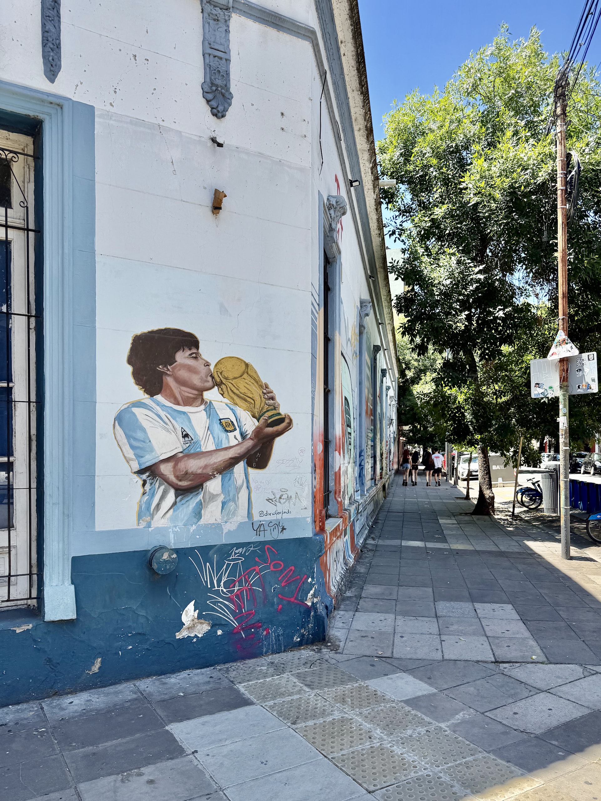 Diego Maradona World Cup mural Buenos Aires Argentina Street mural of Diego Maradona kissing the FIFA World Cup trophy in an Argentina national team jersey, Buenos Aires