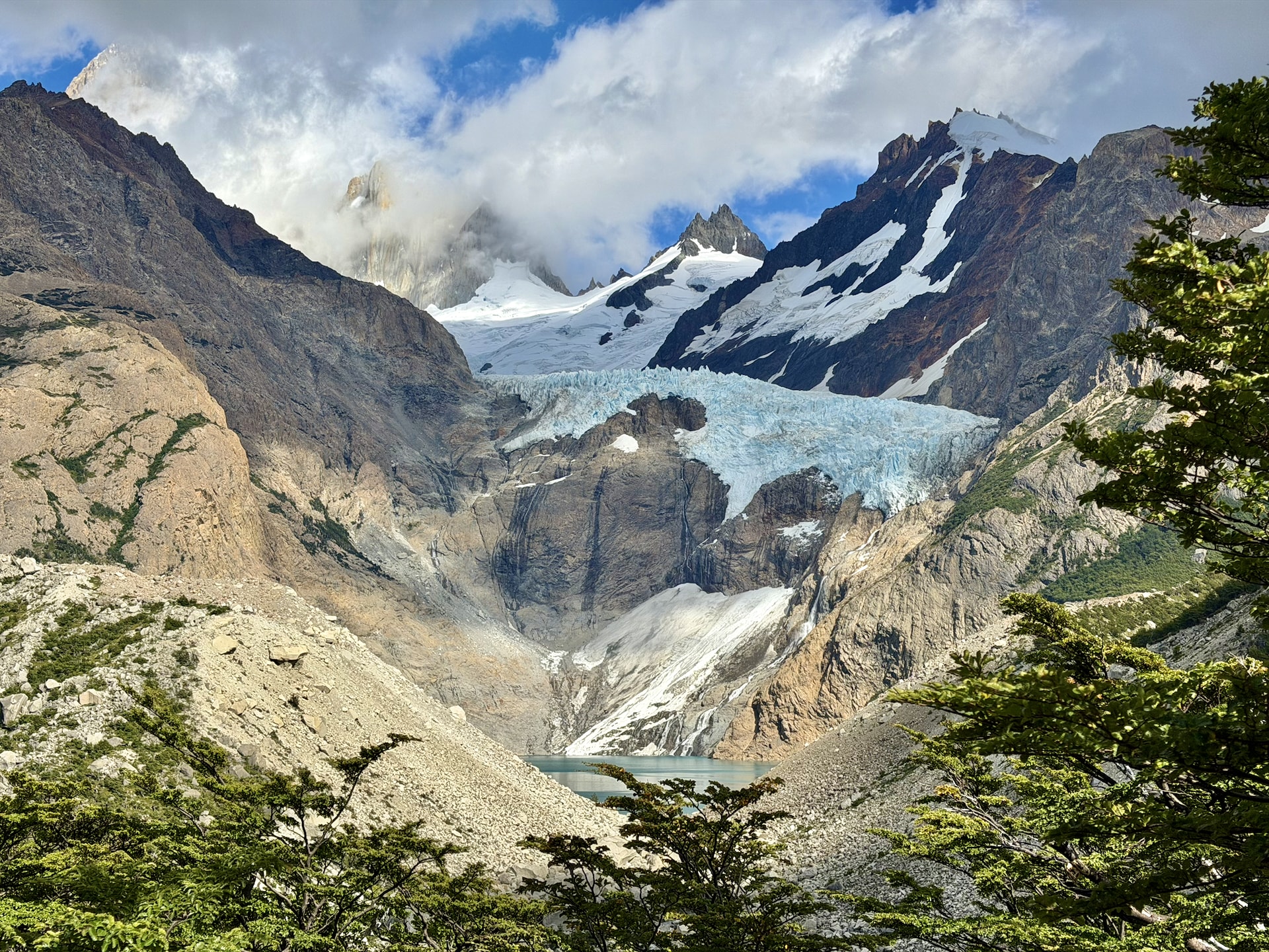 Glacier and glacial lake on Río Eléctrico trail to Mirador de los Tres El Chaltén Glacier descending between steep rocky walls to a turquoise glacial lake on the Río Eléctrico trail toward Mirador de los Tres, El Chaltén, Argentina