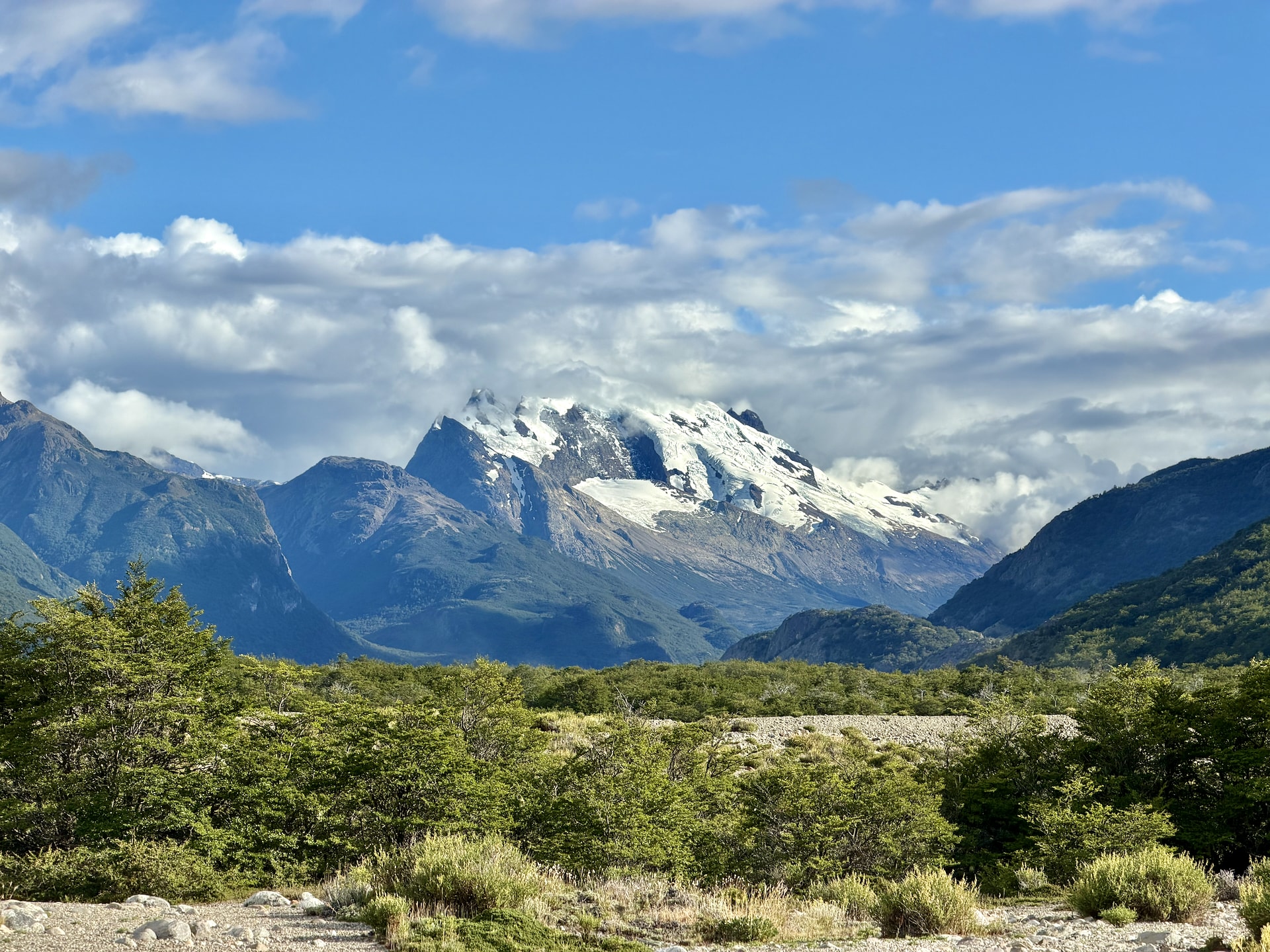 Hiking trail near El Chaltén with typical Patagonian landscape Glaciated peaks above lenga beech forest and gravel riverbed on a hiking trail near El Chaltén, Patagonia, Argentina