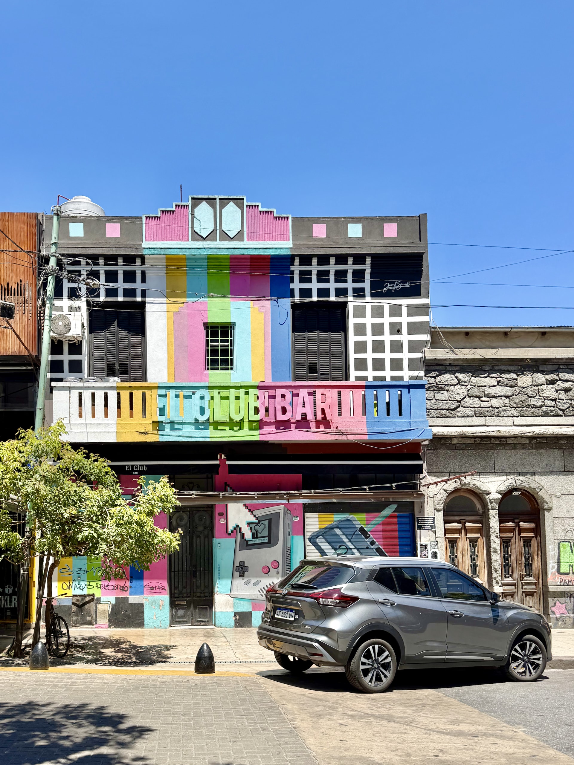 The brightly painted, pixel-art facade of El Club Bar in the Palermo neighborhood of Buenos Aires.