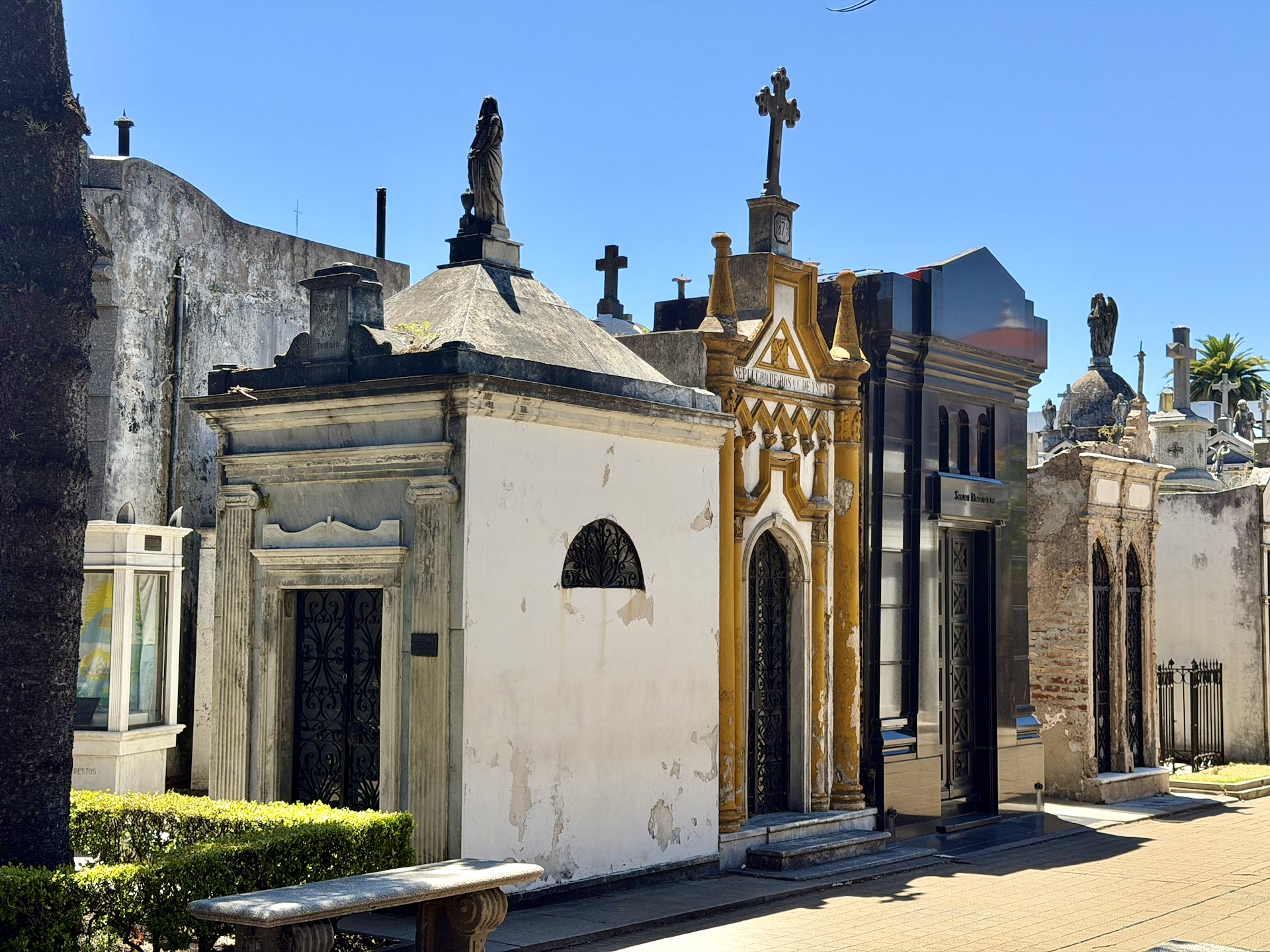 Elaborate marble mausoleums lining a walkway in La Recoleta Cemetery, Buenos Aires.