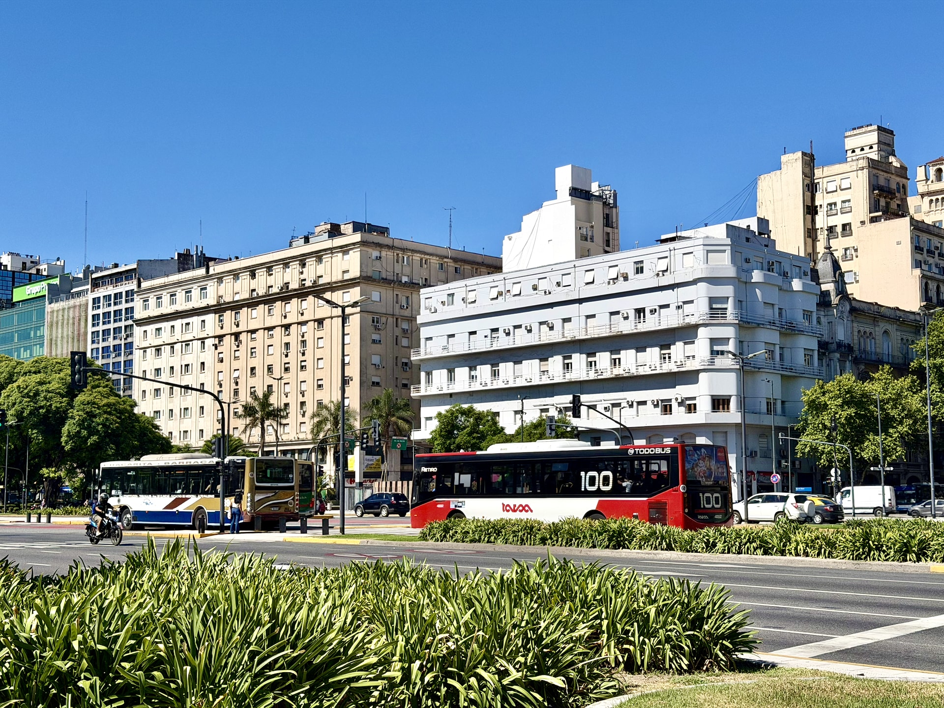 Avenida 9 de Julio, the wide avenue through central Buenos Aires The multi-lane Avenida 9 de Julio in Buenos Aires, with a grassy median and two city buses crossing.