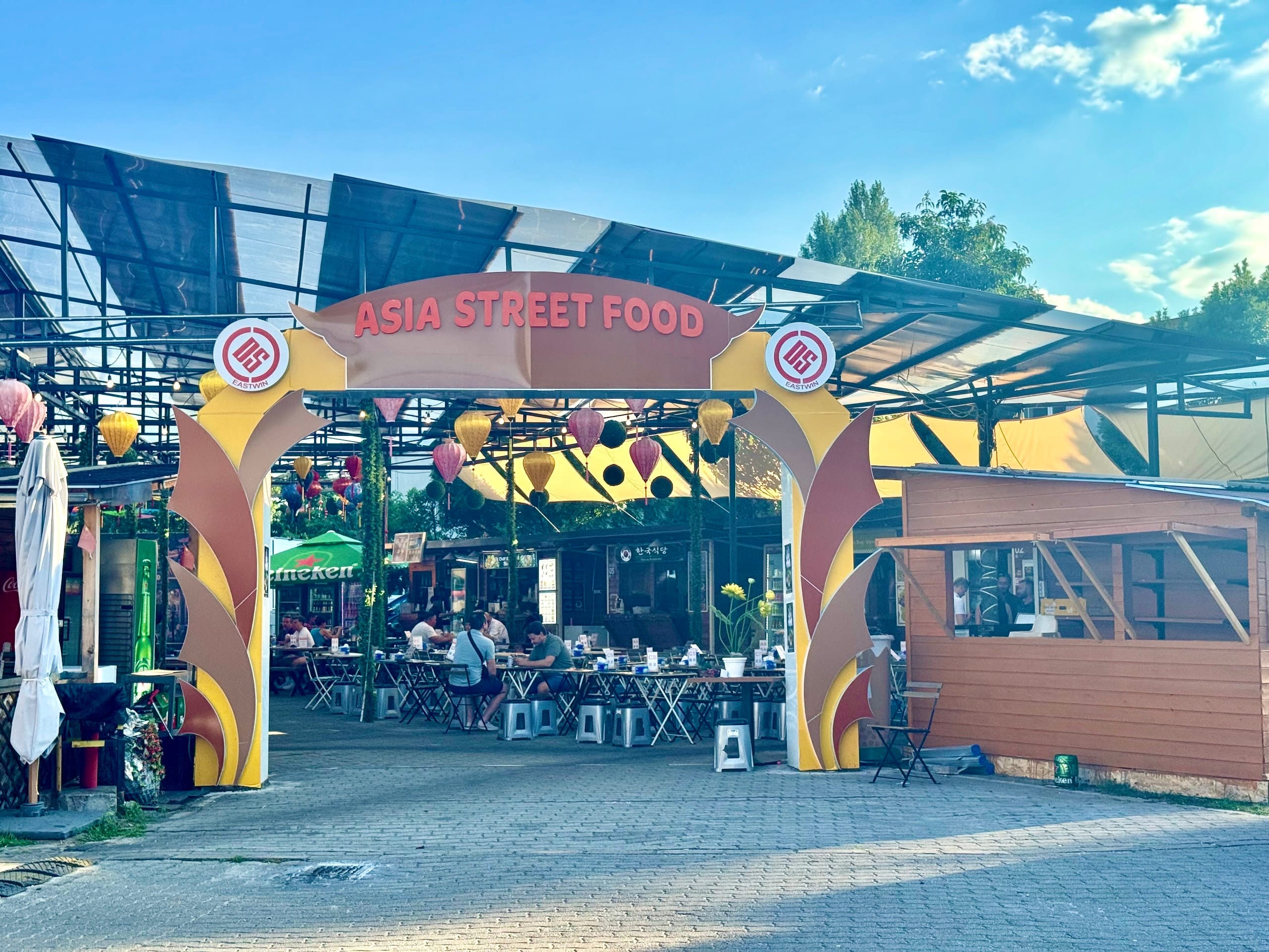 The entrance arch of Bian Garden Budapest with the Asia Street Food sign and colorful lanterns behind it