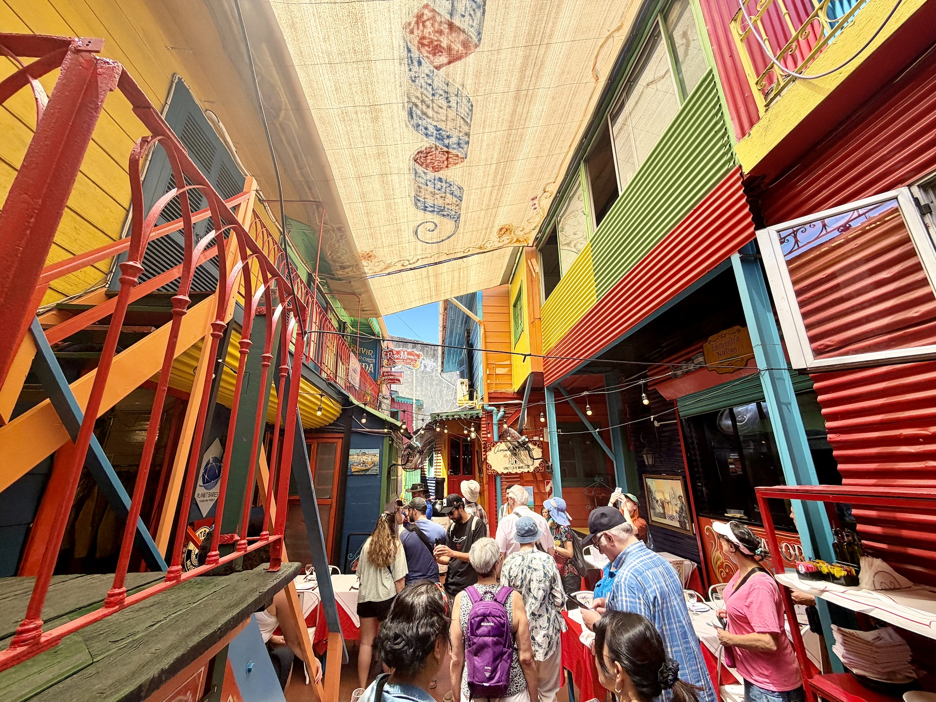 Encuentro Nativo, a tourist stop on La Boca's Magallanes street A crowded, colorfully decorated courtyard restaurant on Magallanes street in La Boca, a tour group gathered inside.
