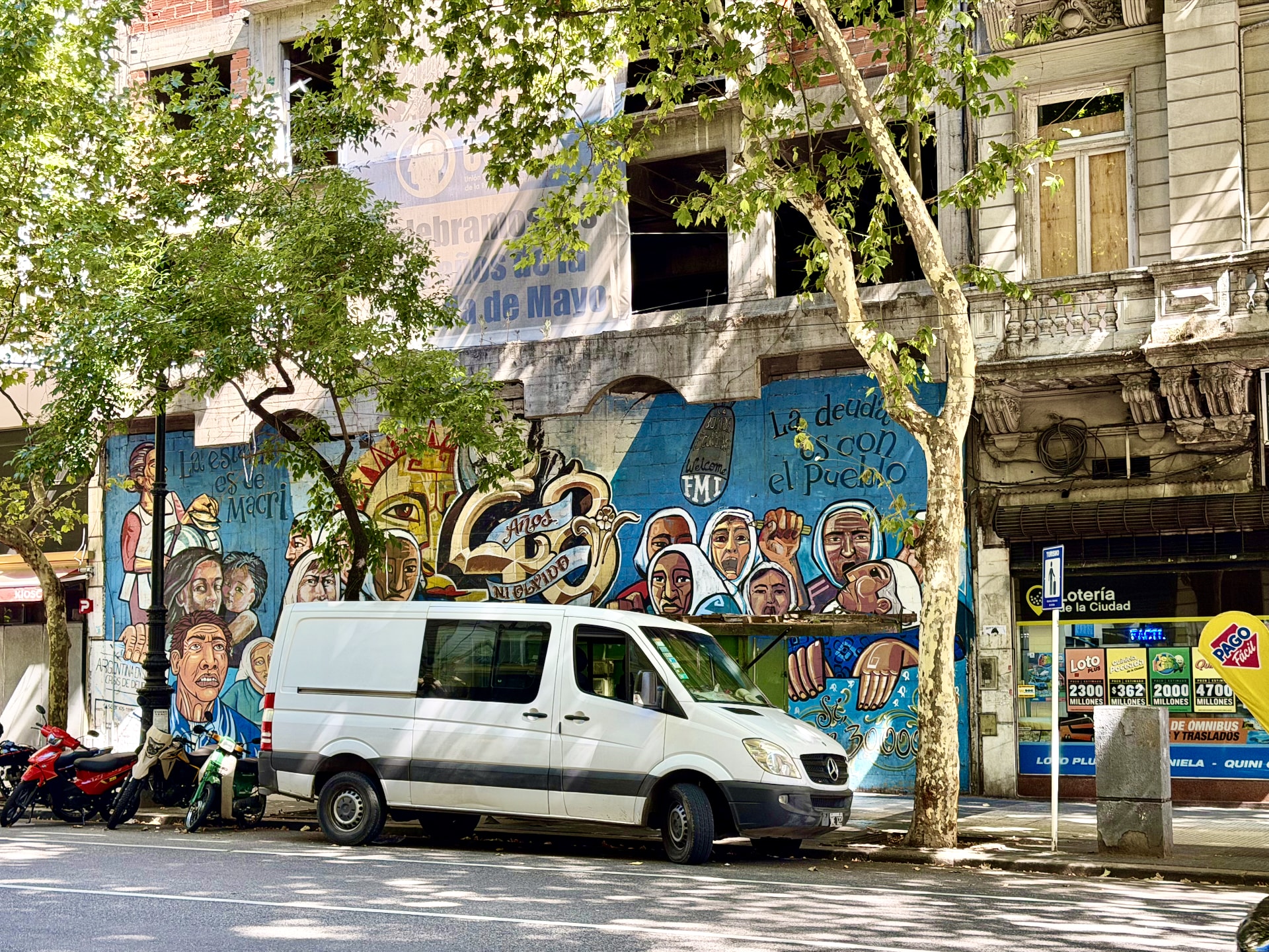 Street art depicting the Madres de Plaza de Mayo A street mural in Buenos Aires depicting women in white headscarves, referencing the Madres de Plaza de Mayo, beside political text about debt.