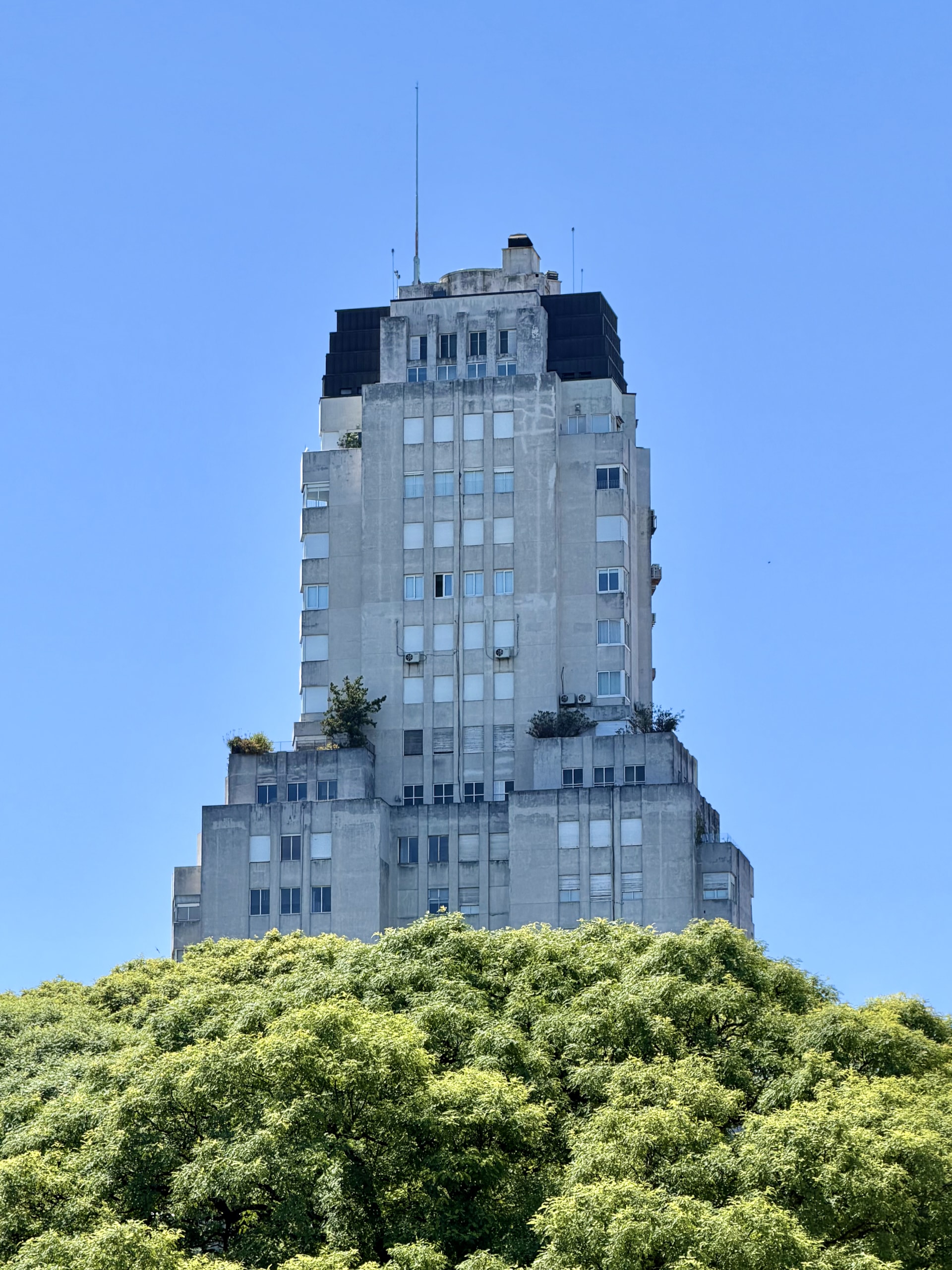 The art deco Kavanagh Building in Buenos Aires The stepped art deco silhouette of the Kavanagh Building rising above the trees of Plaza San Martín.