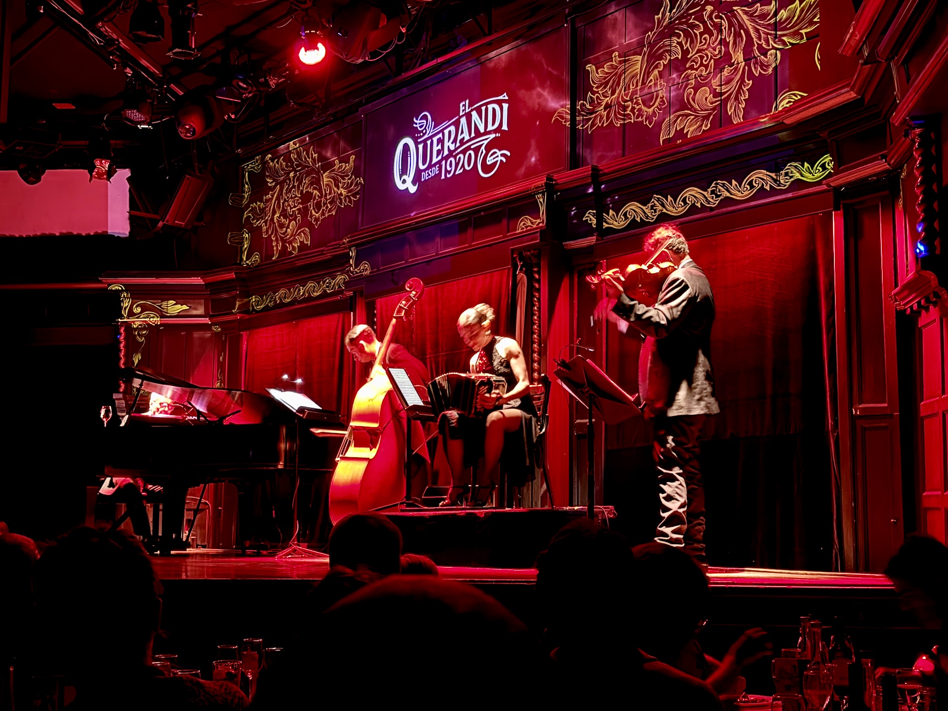The stage at the El Querandí tango show The stage at the El Querandí tango show in Buenos Aires, with a bandoneón player, double bass, violin, and piano.