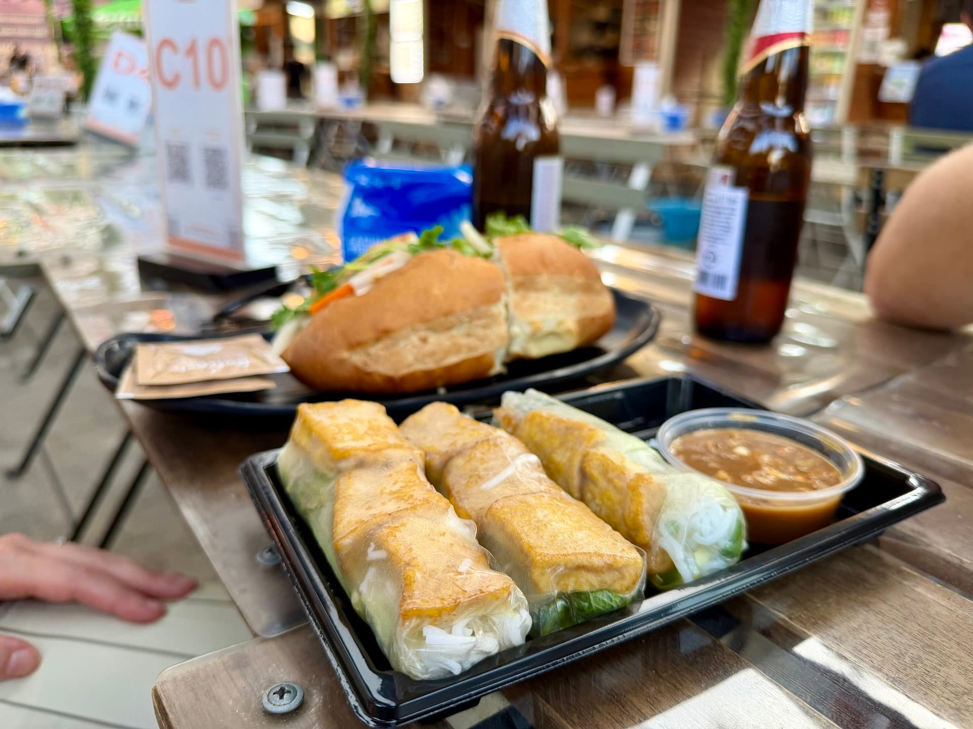 Vietnamese spring rolls and bánh mì at Bian Garden Budapest Tray of Vietnamese fresh spring rolls with peanut dipping sauce, a bánh mì on a plate behind them