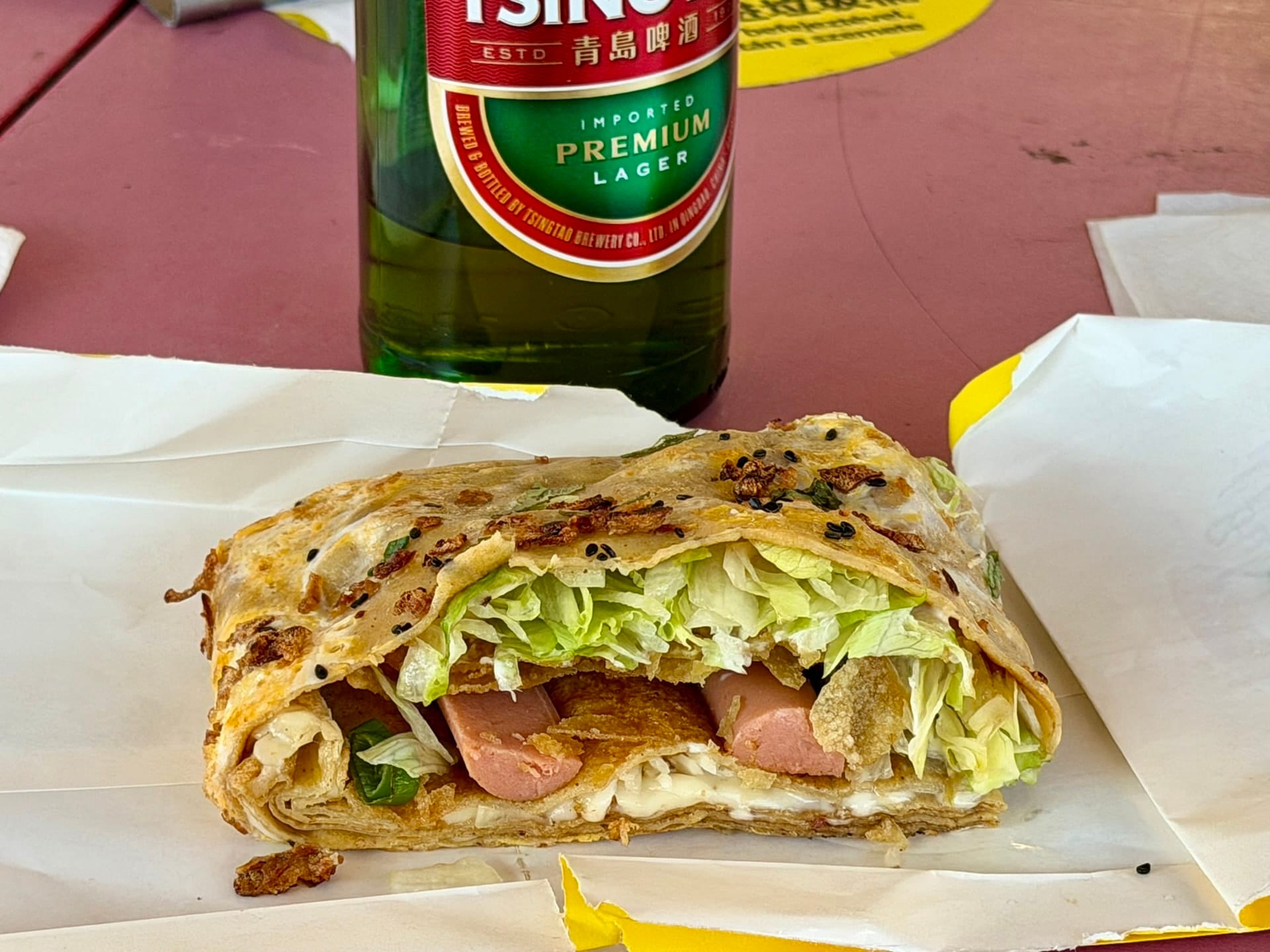 Bing filled with Chinese sausage and cheese at Fully Night Market A bing pancake cut open at Fully Night Market, filled with Chinese sausage, cheese and shredded lettuce, beside a Tsingtao.