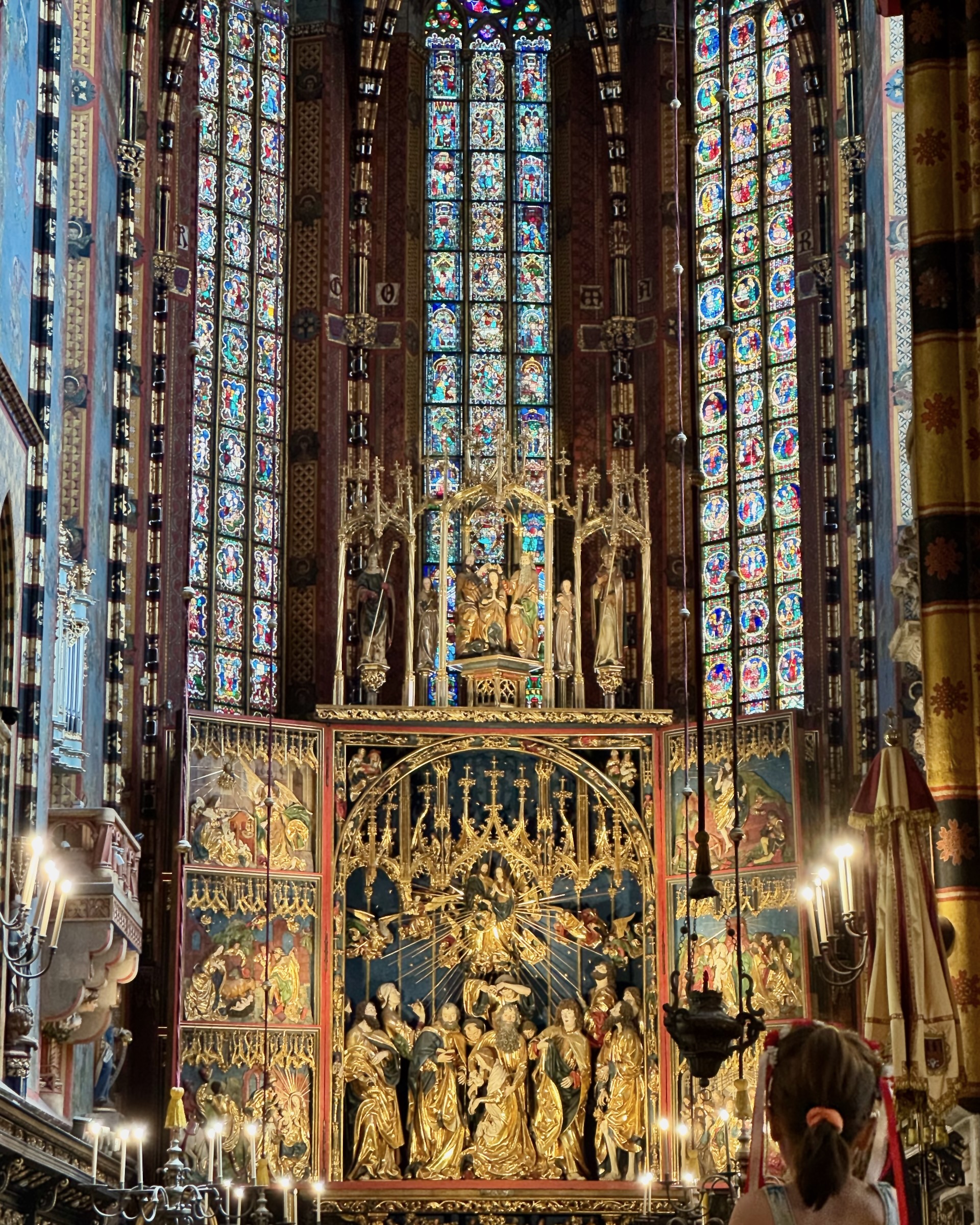 The Veit Stoss altarpiece open inside St Mary's Basilica, gilded figures beneath stained glass