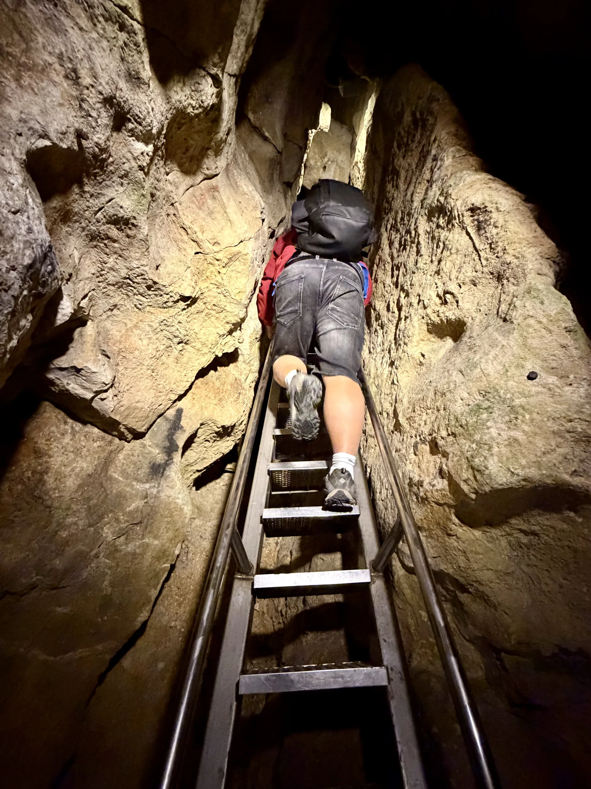 The 7 m ladder from below, Pál-völgyi cave Budapest A visitor climbing the seven metre metal ladder in the Pál-völgyi cave, seen from below