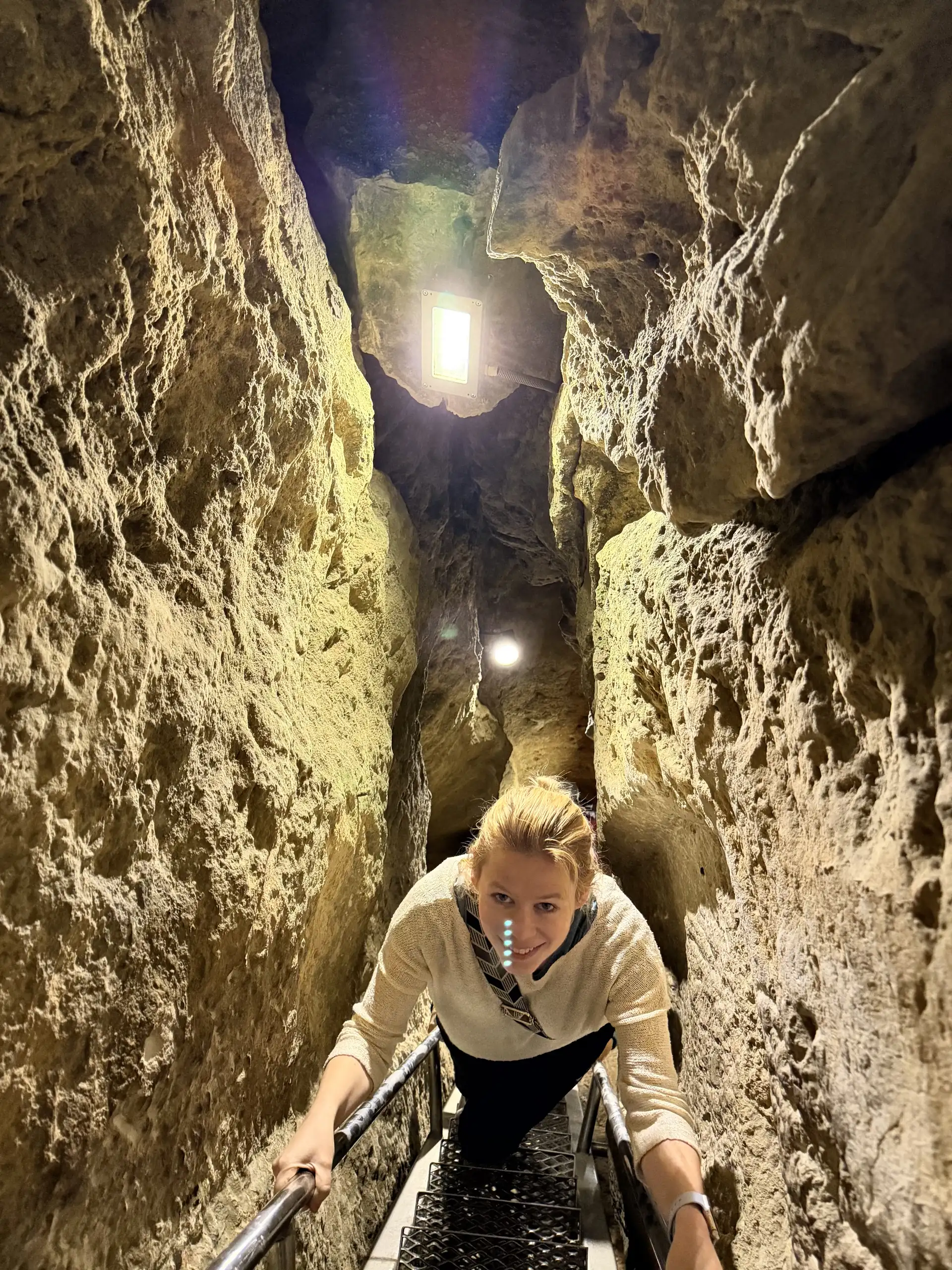 Andrea on the ladder seen from above, Pál-völgyi cave Budapest Andrea climbing the ladder in a narrow fissure in the Pál-völgyi cave, seen from above as she looks up