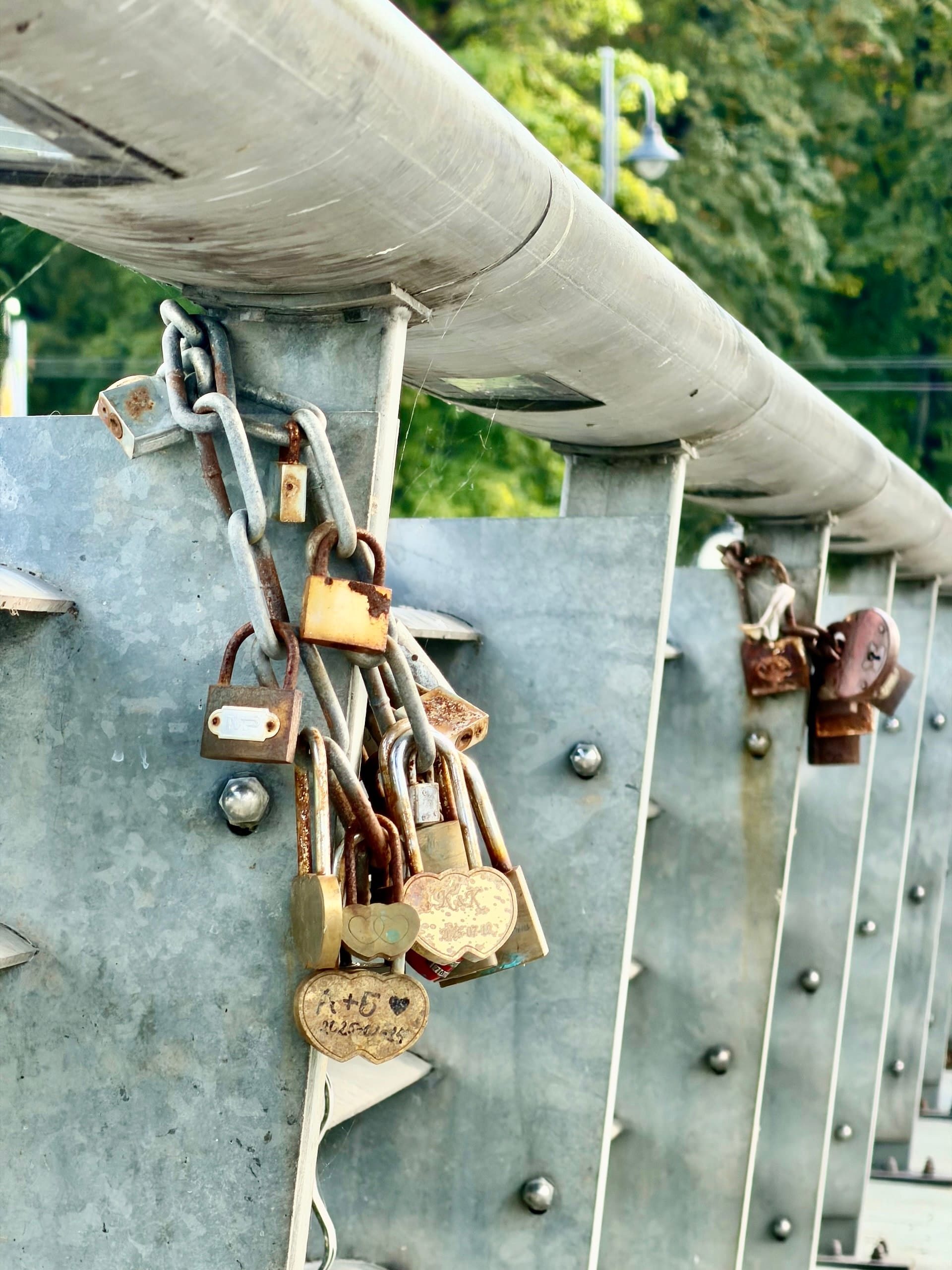 Love locks on a bridge in Vilnius Rusted padlocks chained to the steel railing of a bridge in Vilnius.