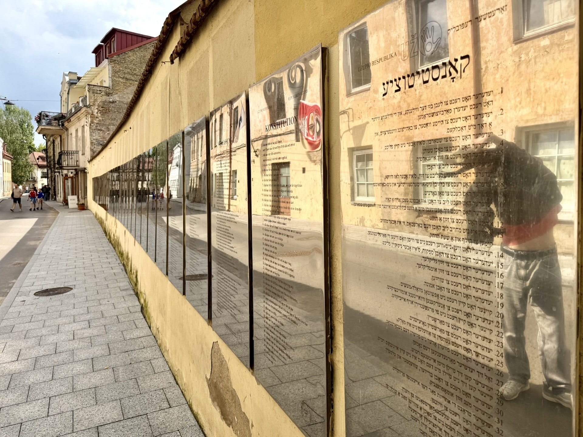 The constitution wall on Paupio street in Užupis The constitution wall on Paupio street in Užupis, dozens of engraved plaques in different languages receding into the distance, the Yiddish one in the foreground.