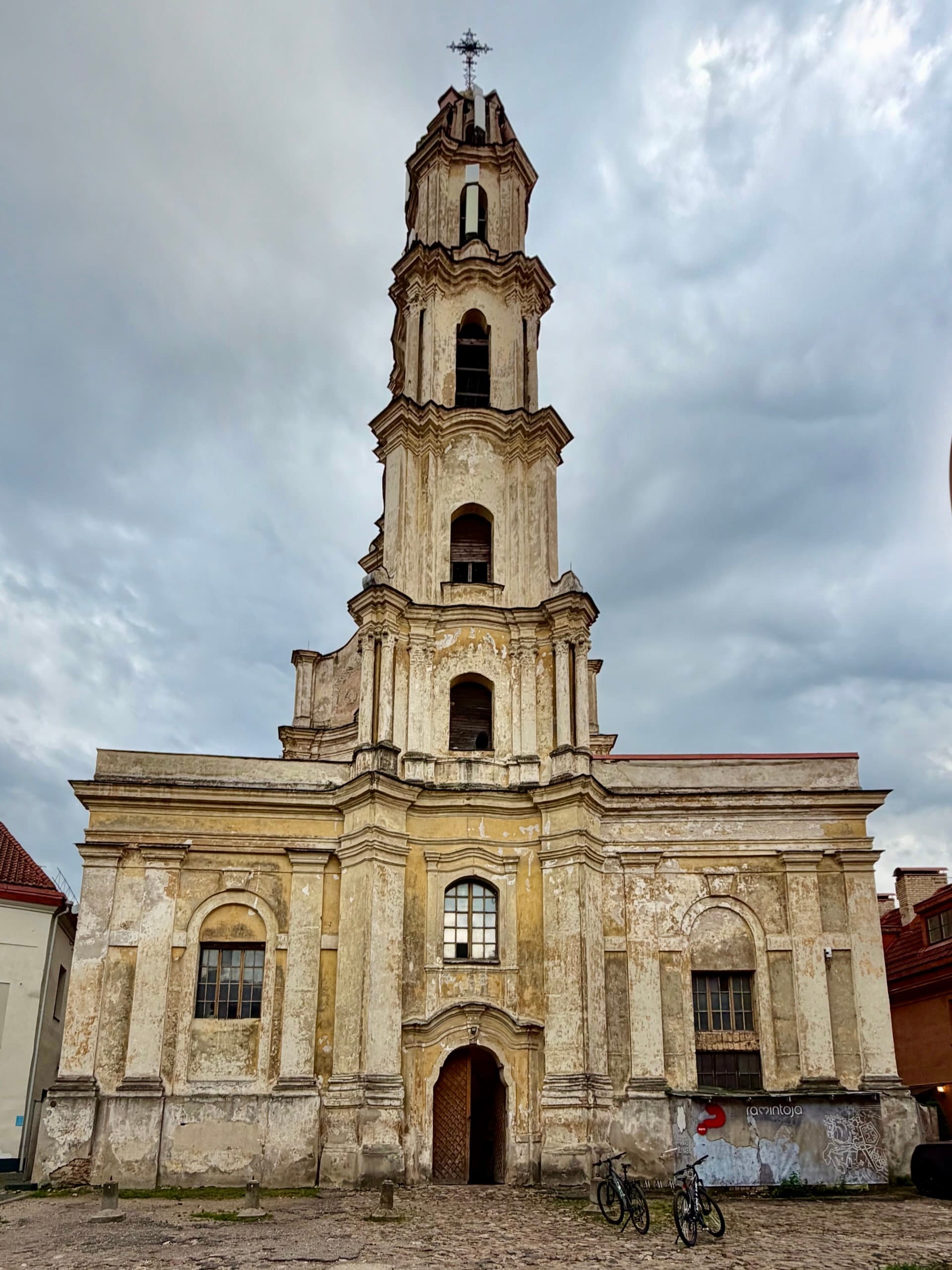 The Ramintoja church, Our Lady of Consolation, Vilnius The weathered facade and four-tier belfry of the Ramintoja church on Savičiaus Street in Vilnius.