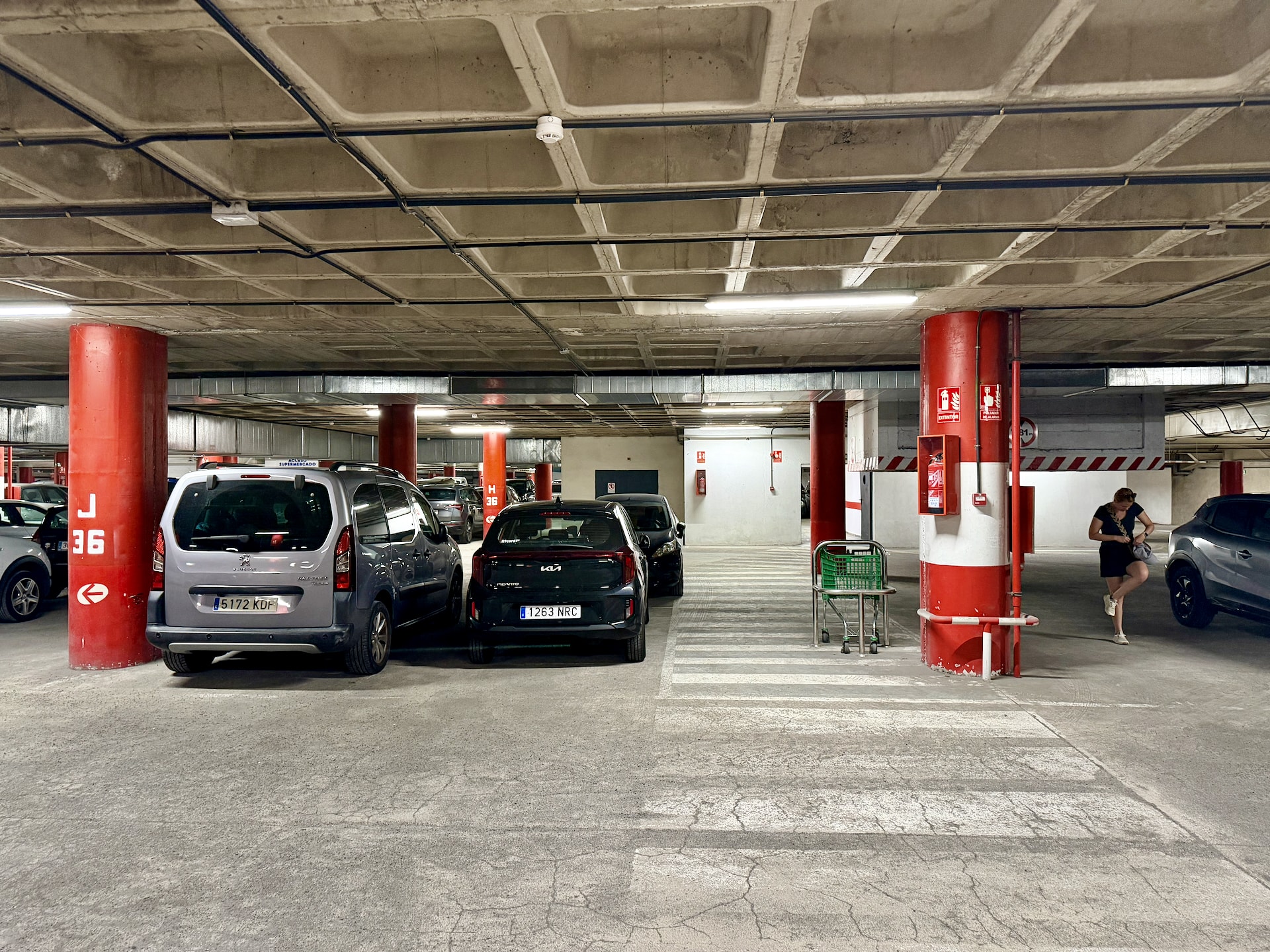 Underground car park with red pillars and parked cars at the C.C. Martiánez shopping center in Puerto de la Cruz