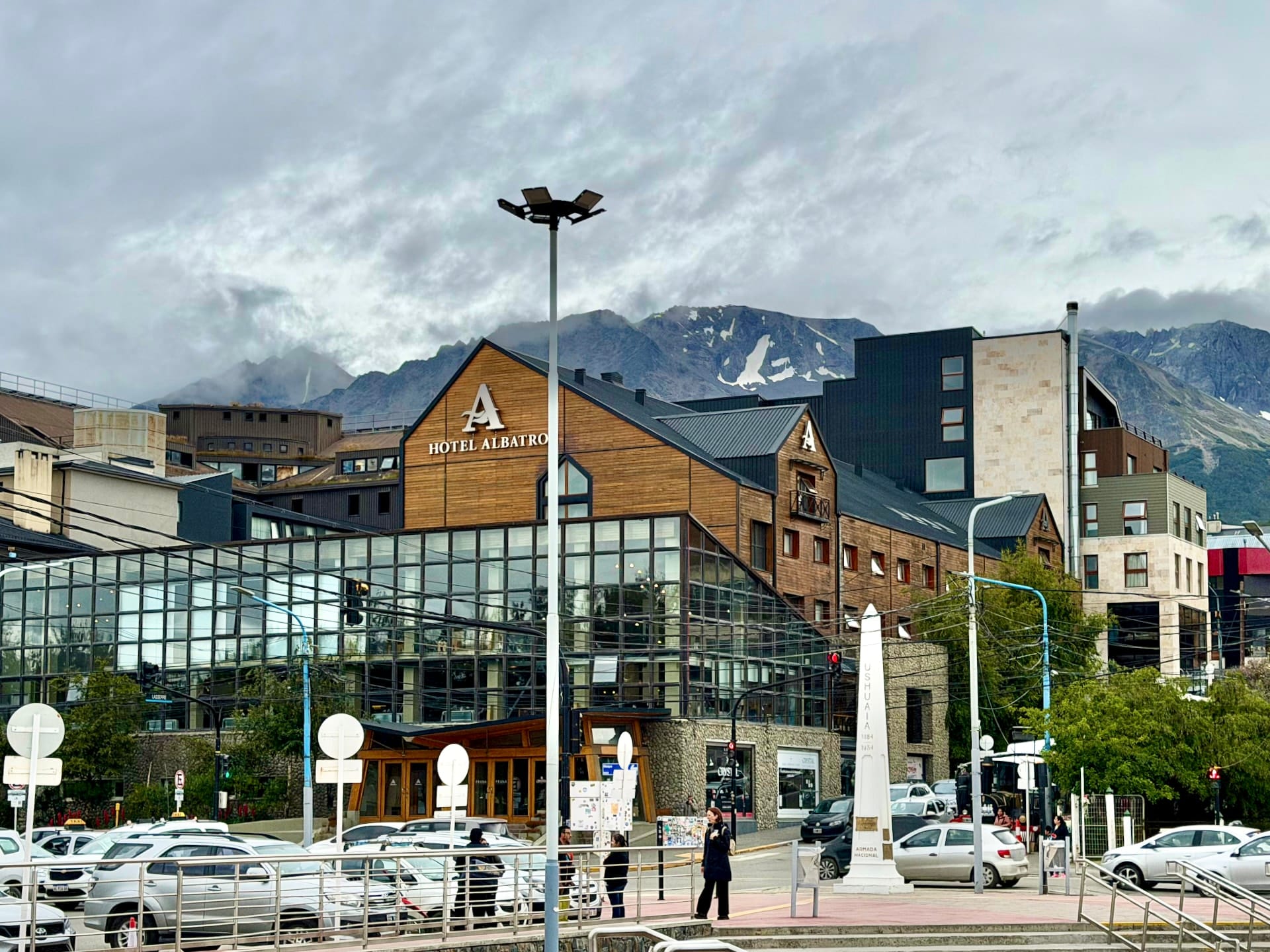 Hotel Albatros on the Ushuaia waterfront, a wood-and-glass building with snowy mountains behind