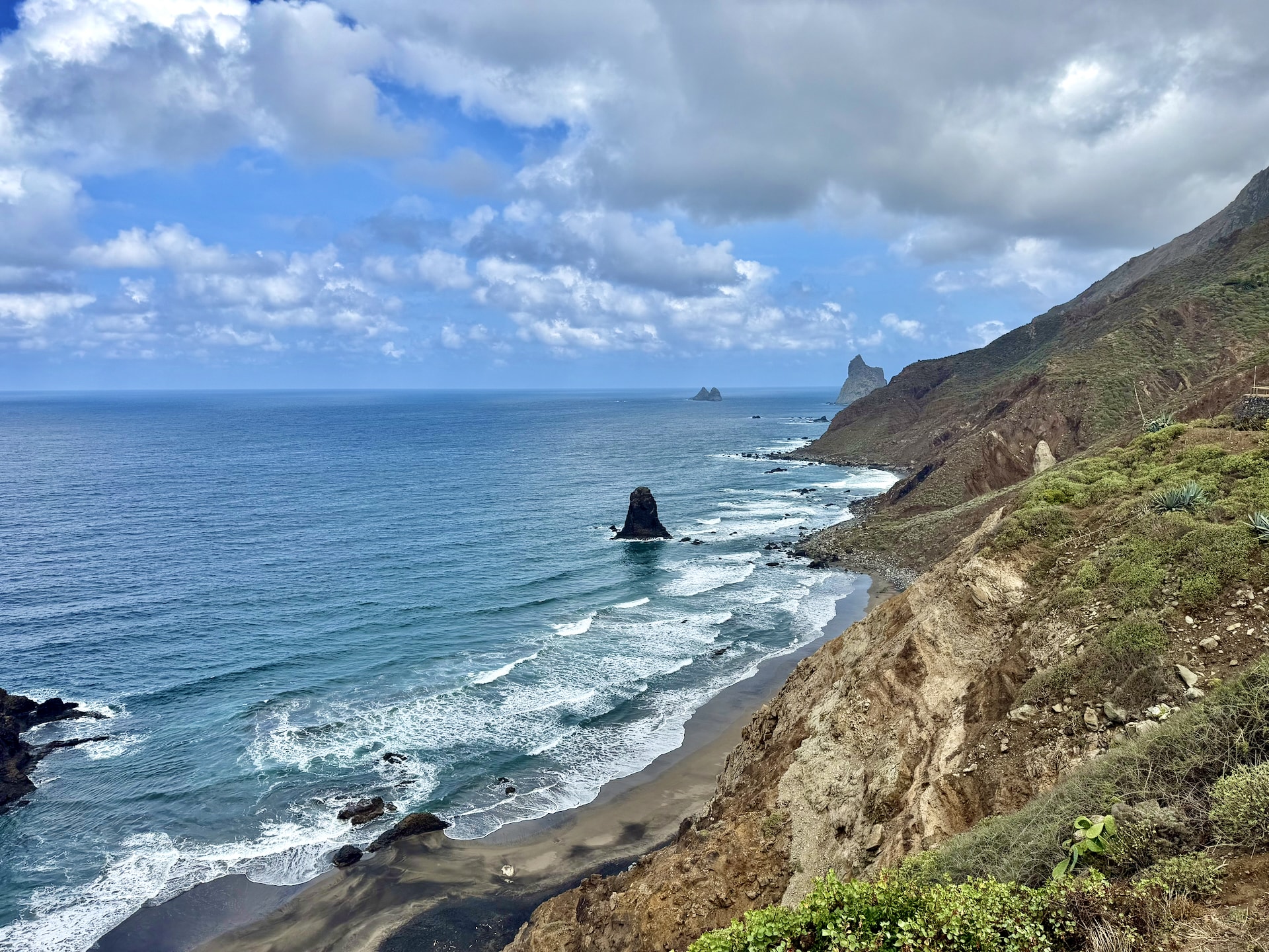 Playa de Benijo from above, Anaga, Tenerife Playa de Benijo from the hillside above: a dark sand beach with a sea stack offshore and the Roques de Anaga on the horizon