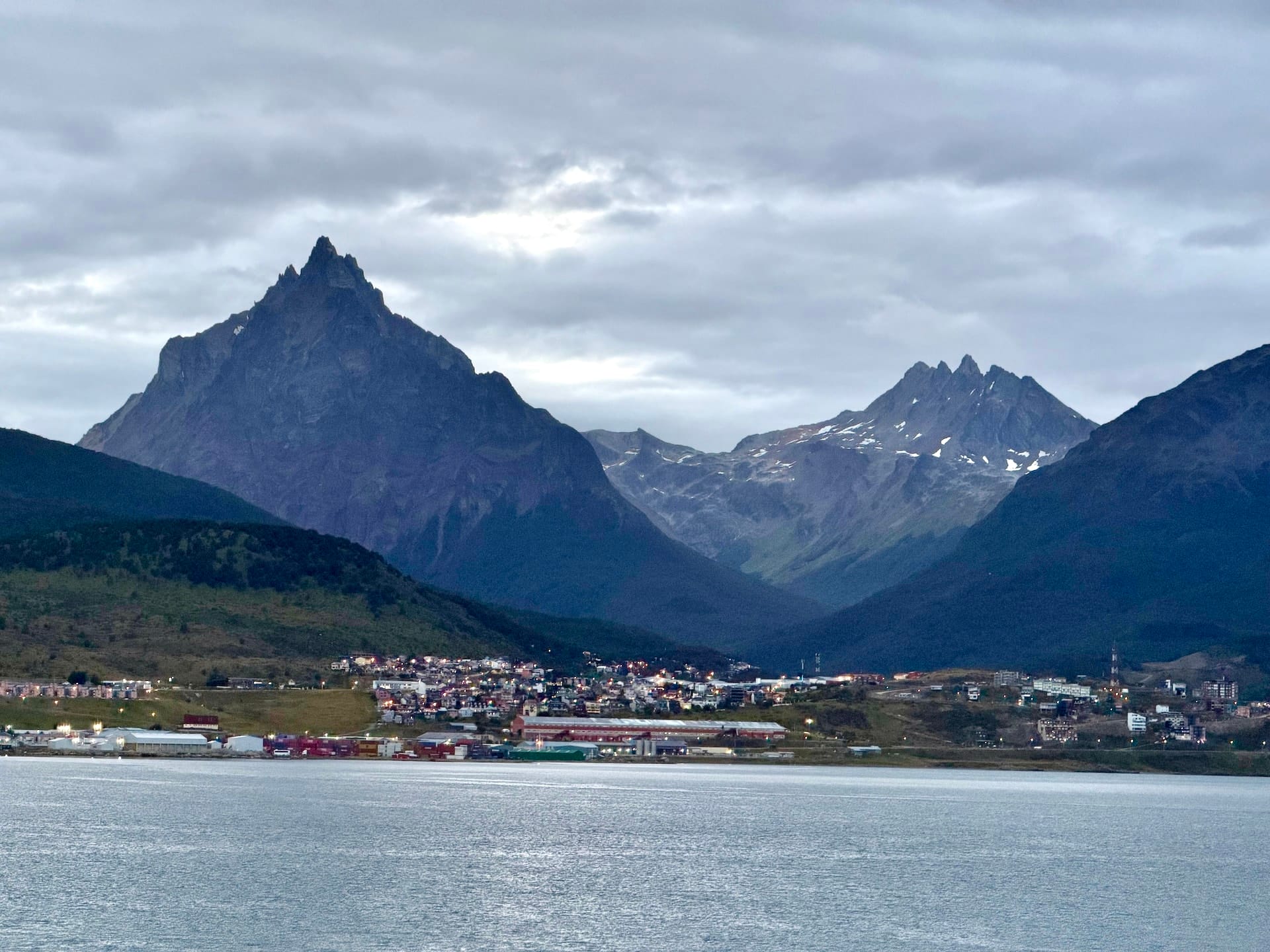 Ushuaia on the shore of the Beagle Channel below the pointed peak of Monte Olivia, seen from the water