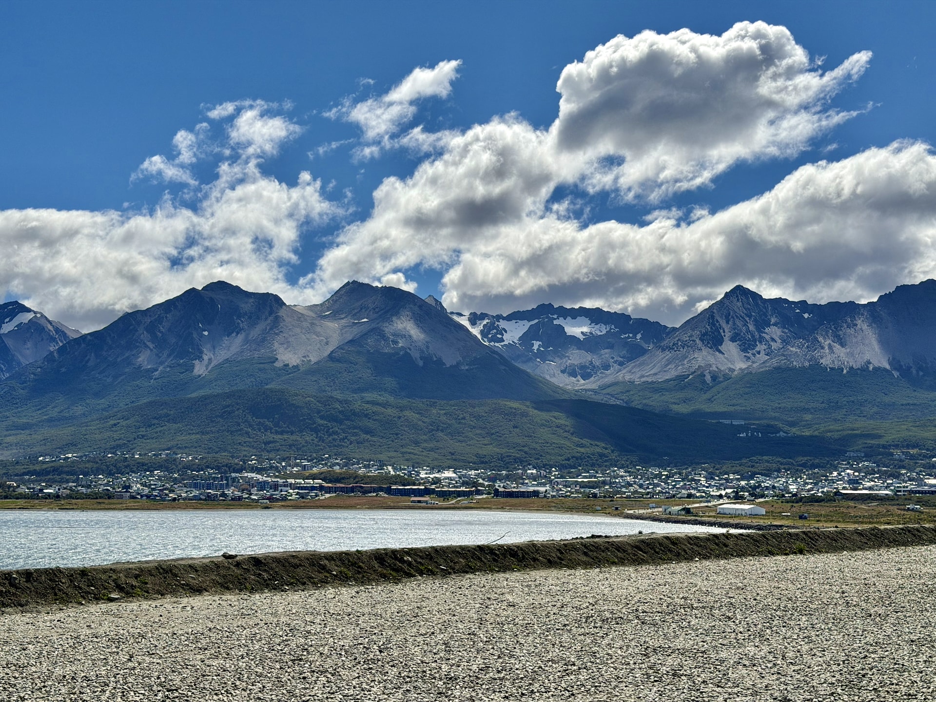 Ushuaia spread along the bay beneath the Martial Mountains, seen across the water from the airport